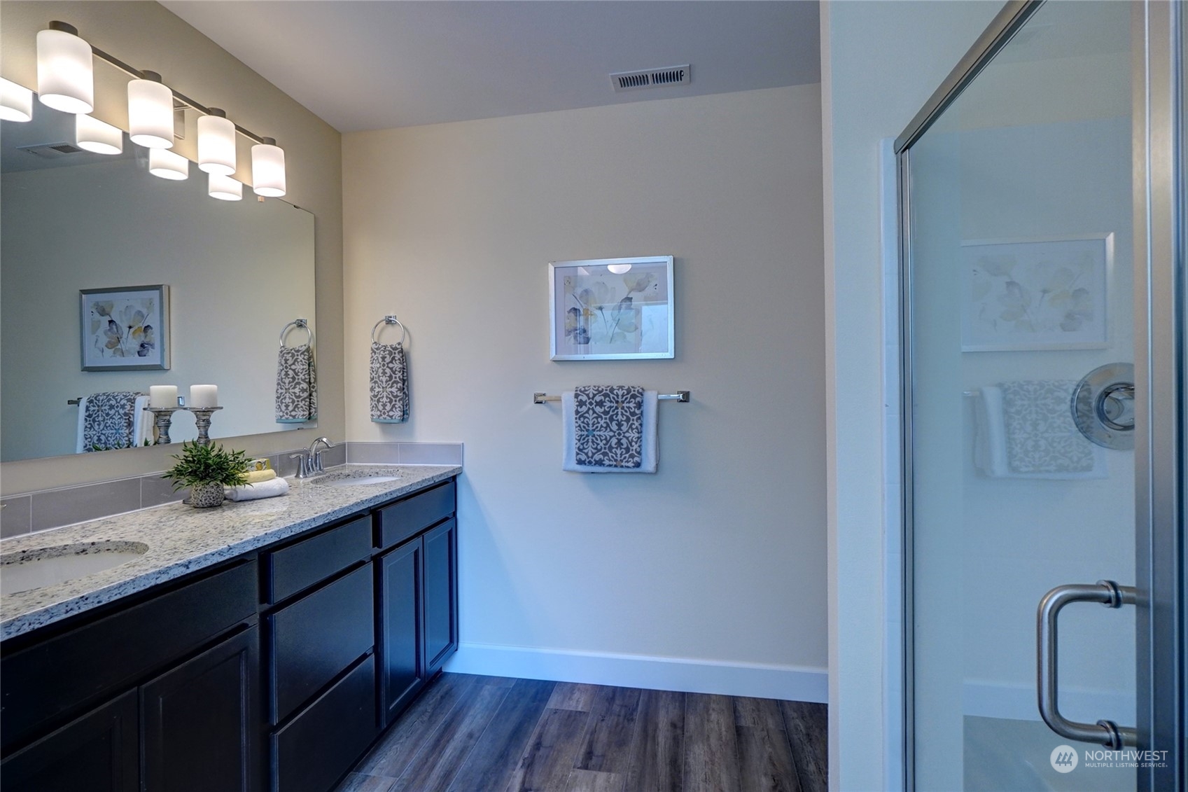10705 36th Street East Edgewood, WA 98372 - Photo 20 of 40 a bathroom with a granite countertop sink a toilet and mirror