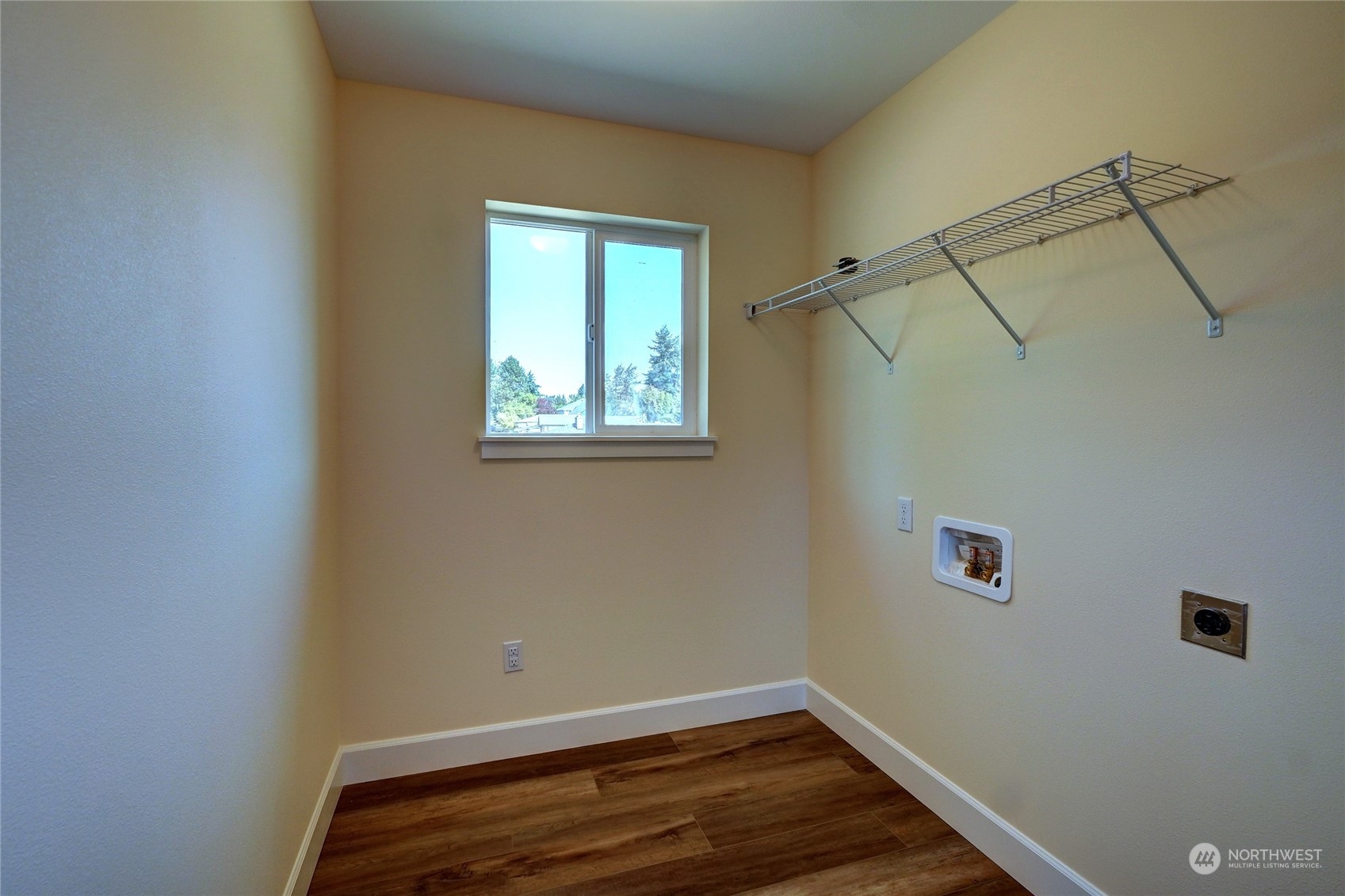10705 36th Street East Edgewood, WA 98372 - Photo 29 of 40 a view of a room with rack on the wall and a window