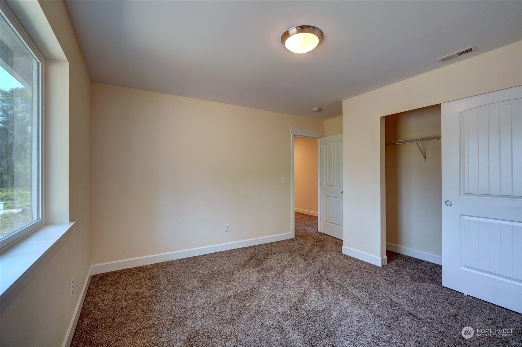10705 36th Street East Edgewood, WA 98372 - Photo 32 of 40 an empty room with windows and closet