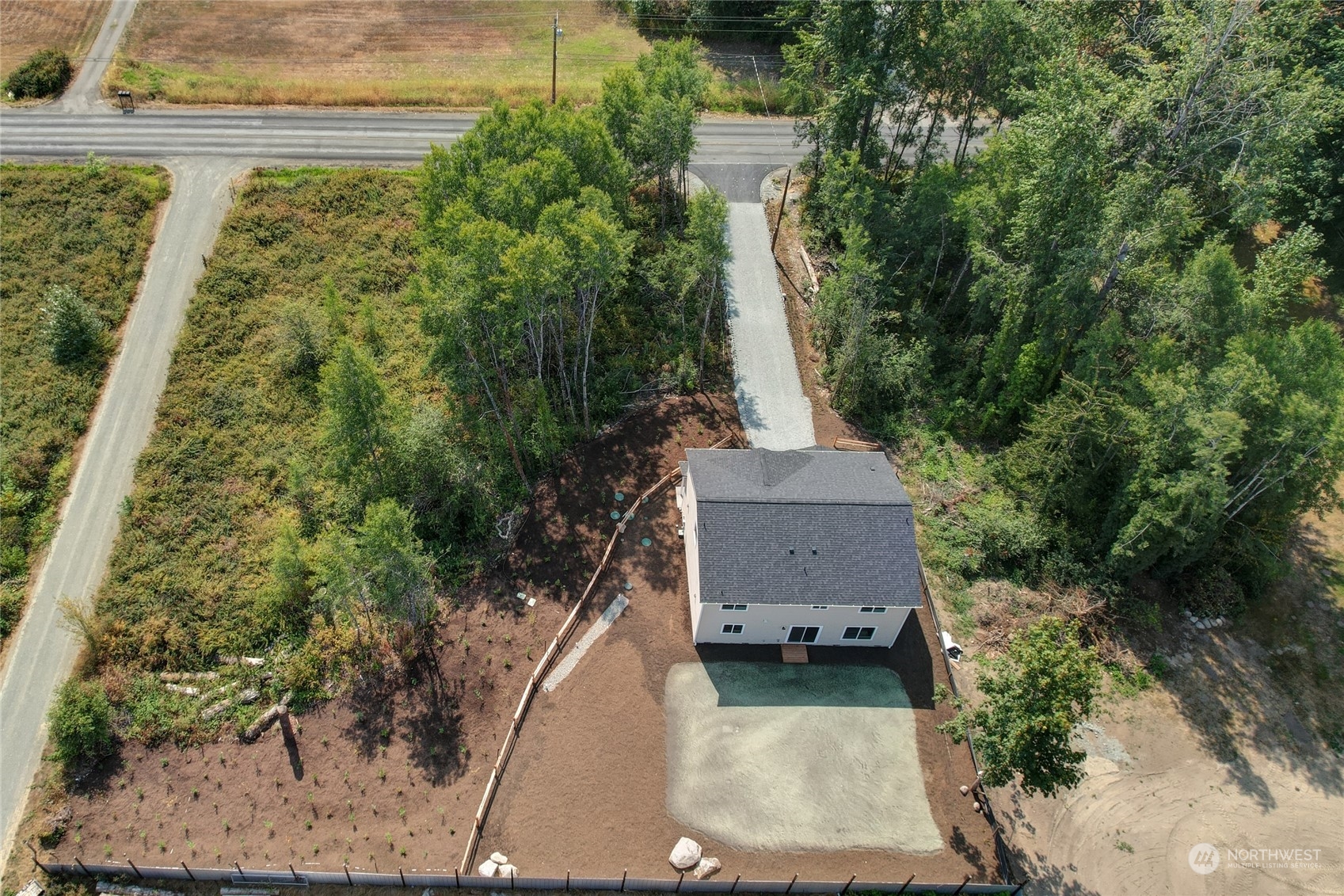 10705 36th Street East Edgewood, WA 98372 - Photo 33 of 40 an aerial view of a house with a yard and trees