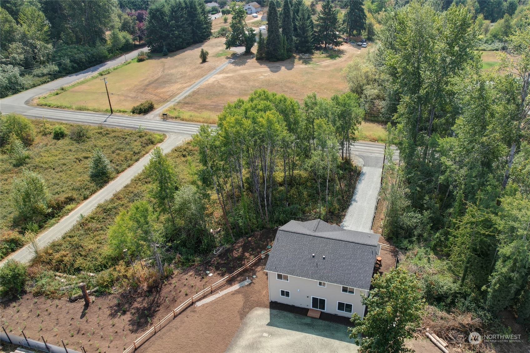 10705 36th Street East Edgewood, WA 98372 - Photo 36 of 40 a aerial view of a house with a yard and lake view