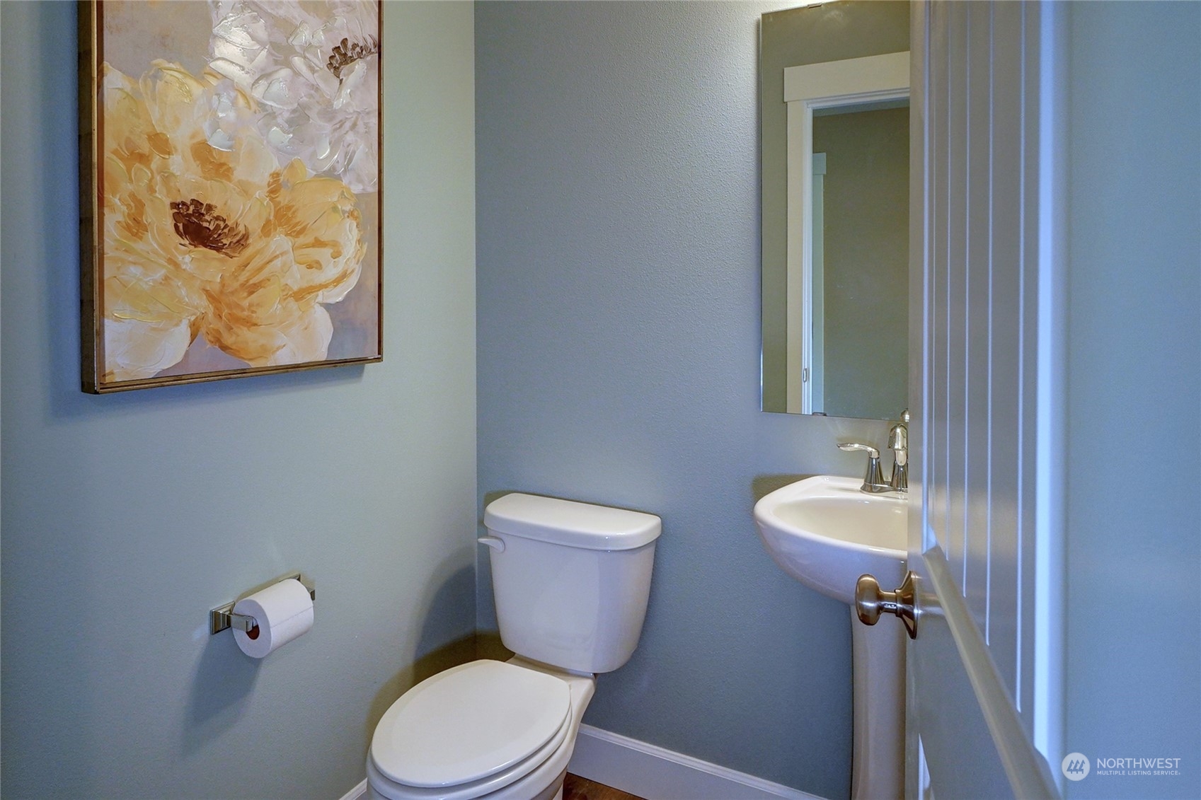 10705 36th Street East Edgewood, WA 98372 - Photo 5 of 40 a bathroom with a toilet sink and mirror