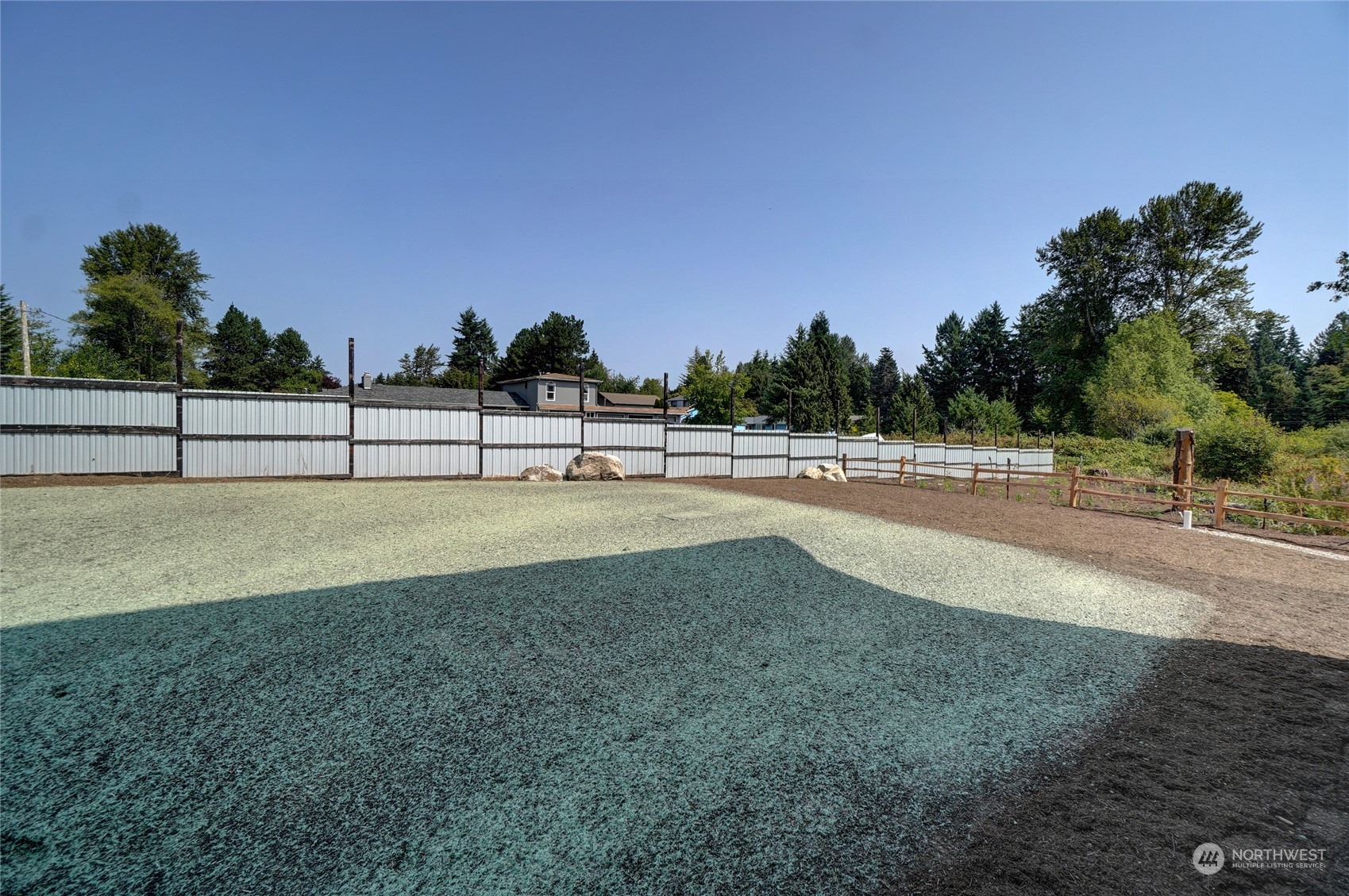 10705 36th Street East Edgewood, WA 98372 - Photo 9 of 40 a view of pool and trees in the background