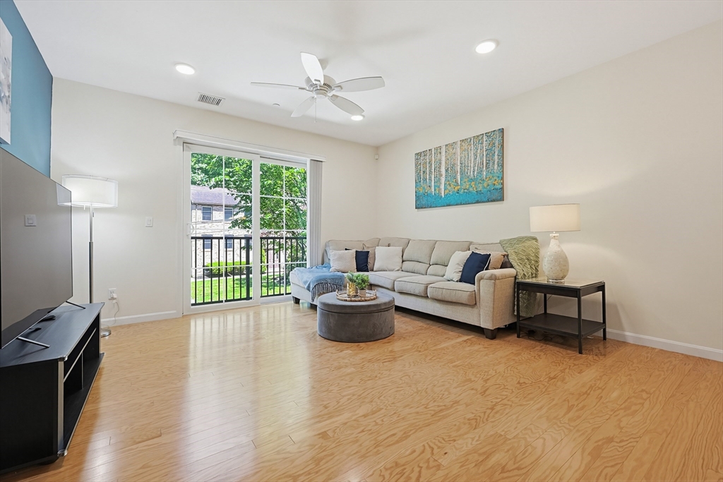 200 Revere Street, Unit 4209 Canton, MA 02021 - Photo 17 of 35 a living room with furniture and a potted plant