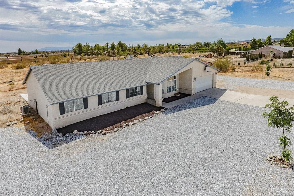 12255 Desert Ranch Road Phelan, CA 92371 - Photo 1 of 1 a view of a terrace with a couple of houses