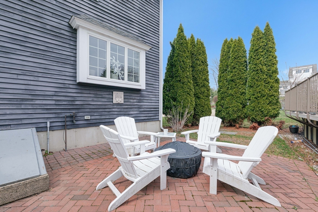 54 Old Merrill Street Amesbury, MA 01913 - Photo 32 of 34 a view of a patio with couple of chairs and a fire pit