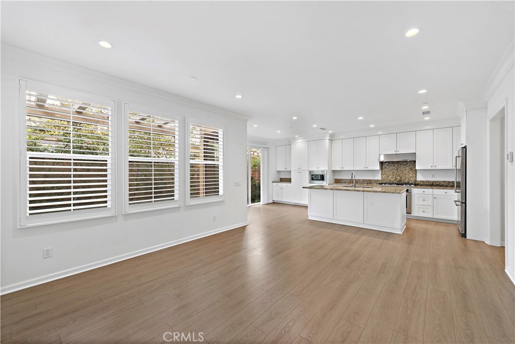a view of a kitchen with a sink and wooden floor