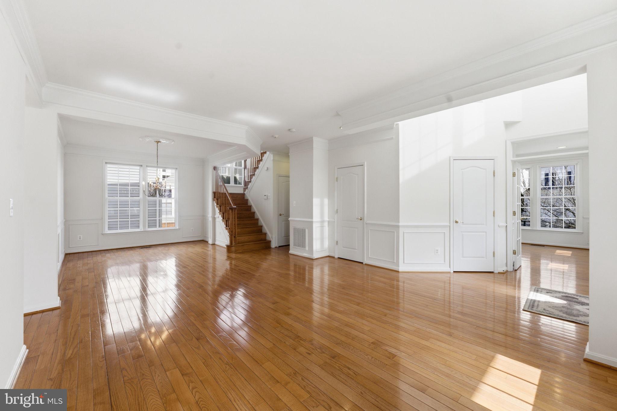 43358 Fullerton Street Ashburn, VA 20147 - Photo 54 of 54 a view of empty room with wooden floor and kitchen view