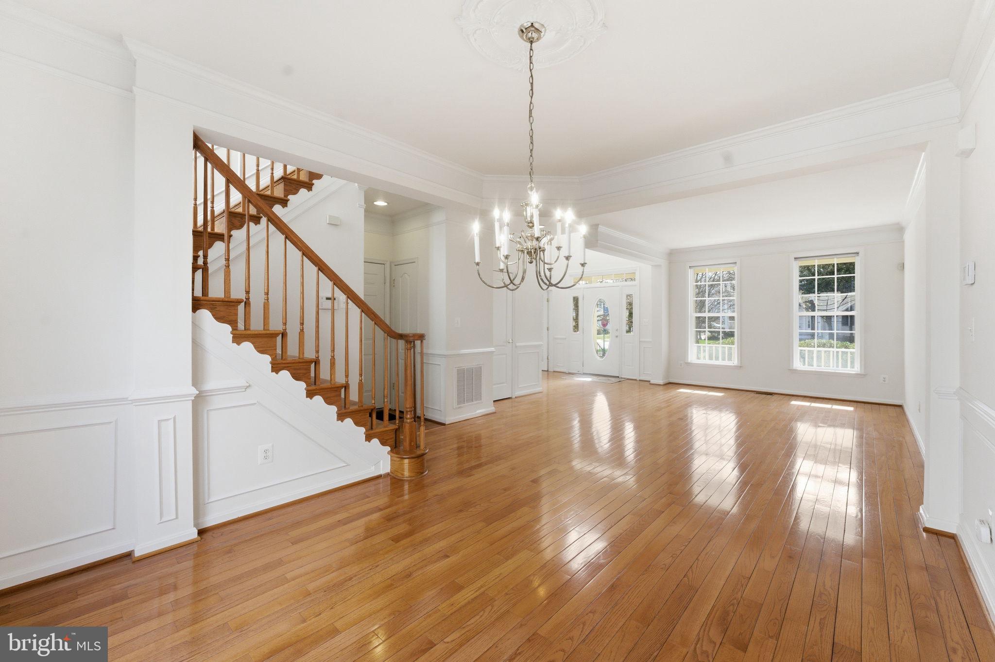43358 Fullerton Street Ashburn, VA 20147 - Photo 11 of 54 a view of an empty room with wooden floor and a chandelier