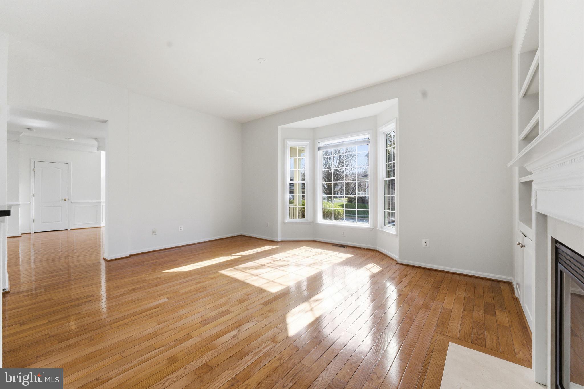 43358 Fullerton Street Ashburn, VA 20147 - Photo 15 of 54 a view of an empty room with wooden floor and a window