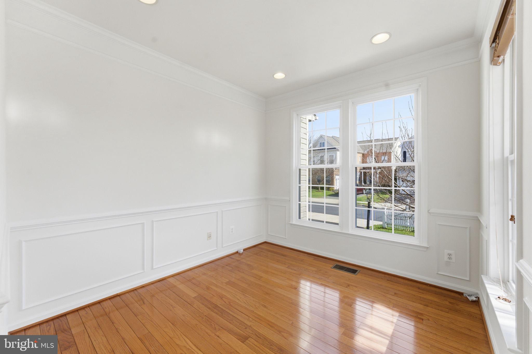 43358 Fullerton Street Ashburn, VA 20147 - Photo 21 of 54 an empty room with wooden floor and windows