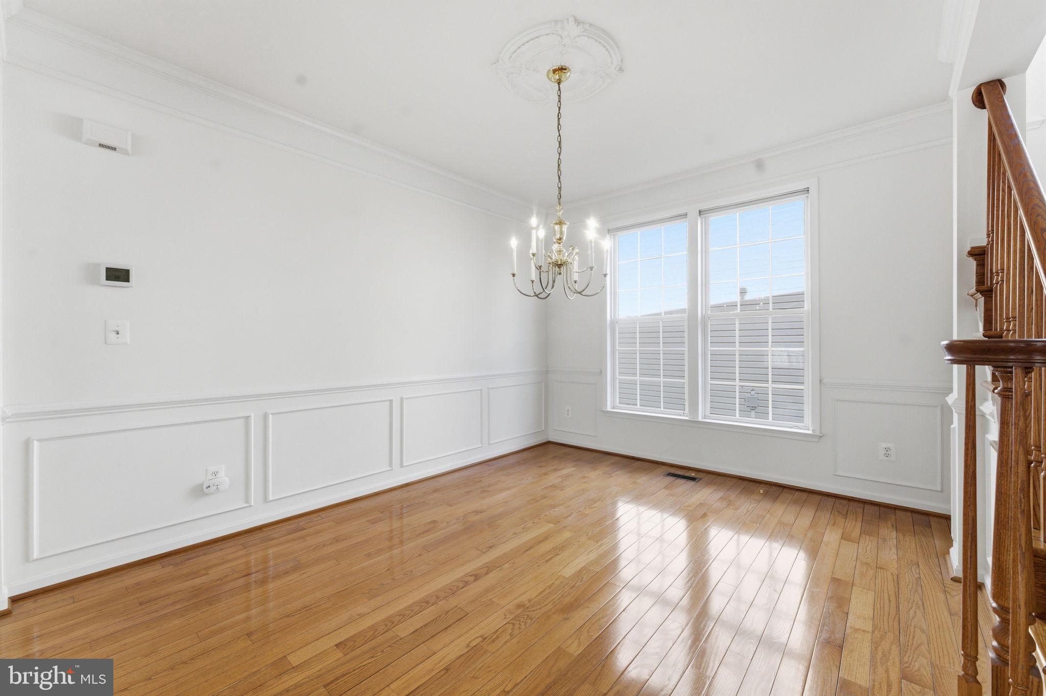 43358 Fullerton Street Ashburn, VA 20147 - Photo 24 of 54 a view of an empty room with wooden floor and a window