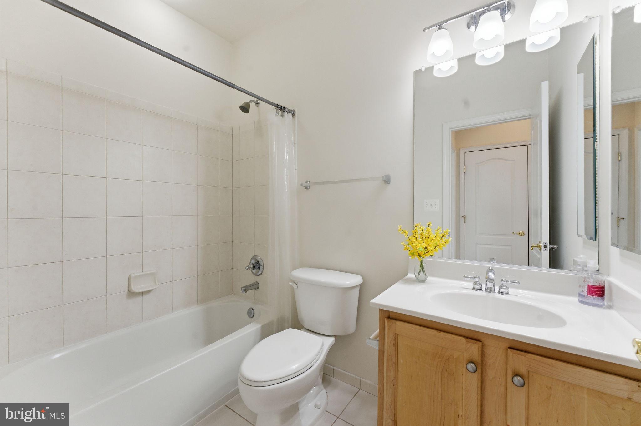 43358 Fullerton Street Ashburn, VA 20147 - Photo 50 of 54 a bathroom with a granite countertop toilet sink and a mirror