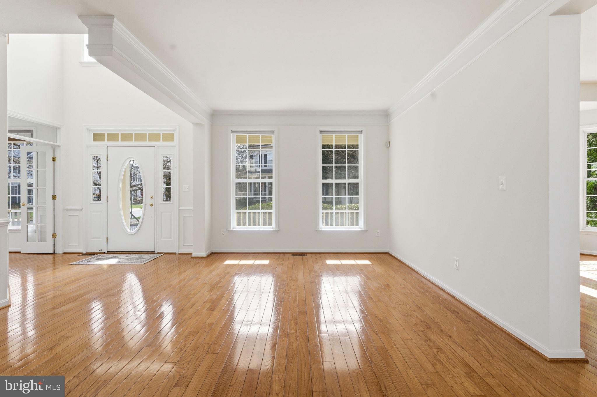 43358 Fullerton Street Ashburn, VA 20147 - Photo 8 of 54 a view of an empty room with wooden floor and a window