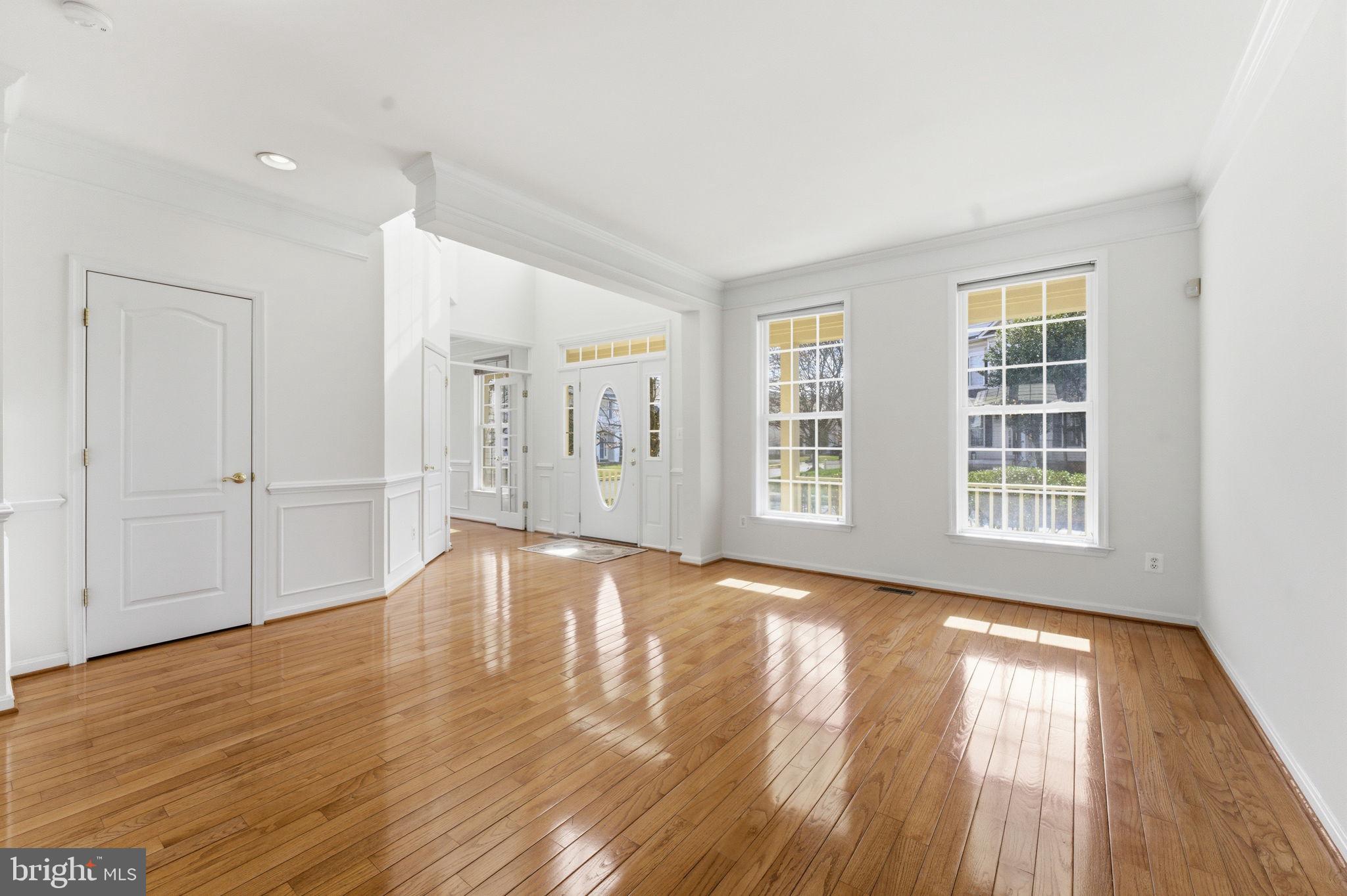 43358 Fullerton Street Ashburn, VA 20147 - Photo 9 of 54 a view of an empty room with wooden floor and a window