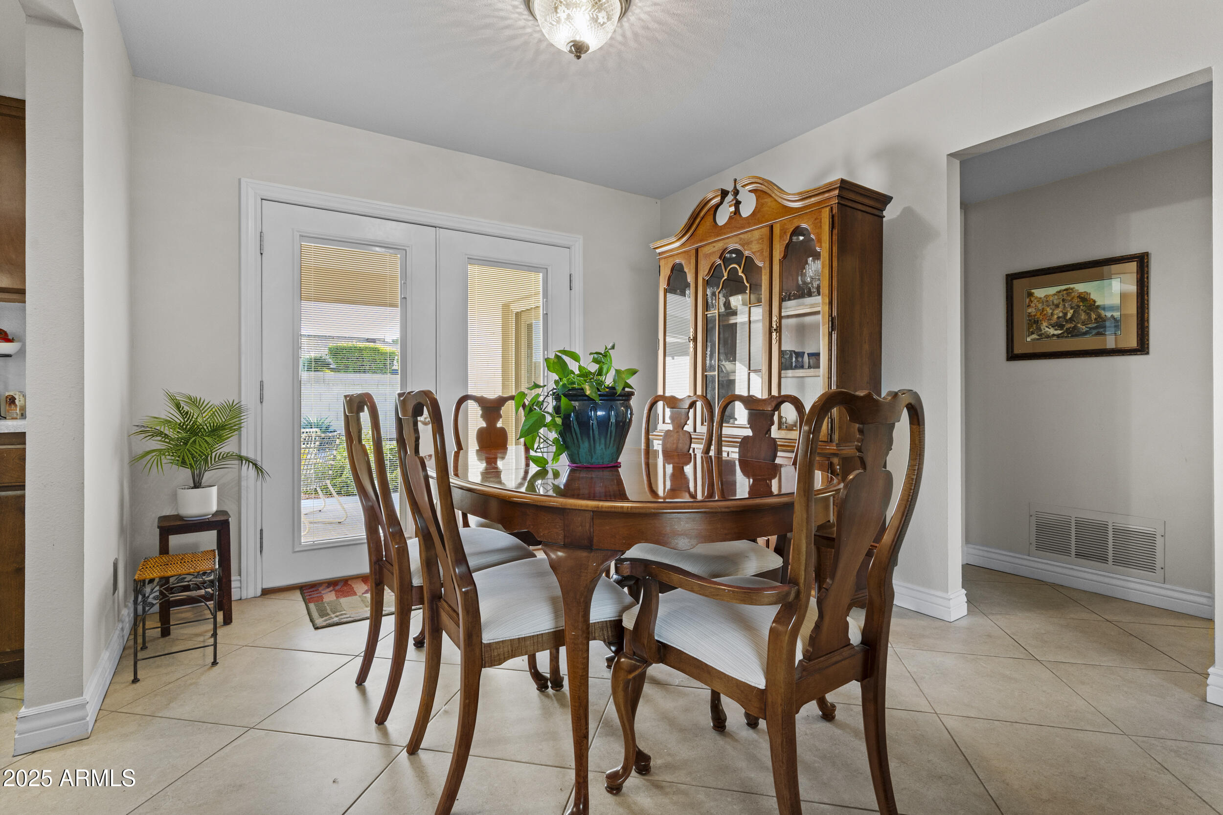 1019 East Watson Drive Tempe, AZ 85283 - Photo 13 of 46 a dining room with furniture potted plants and wooden floor