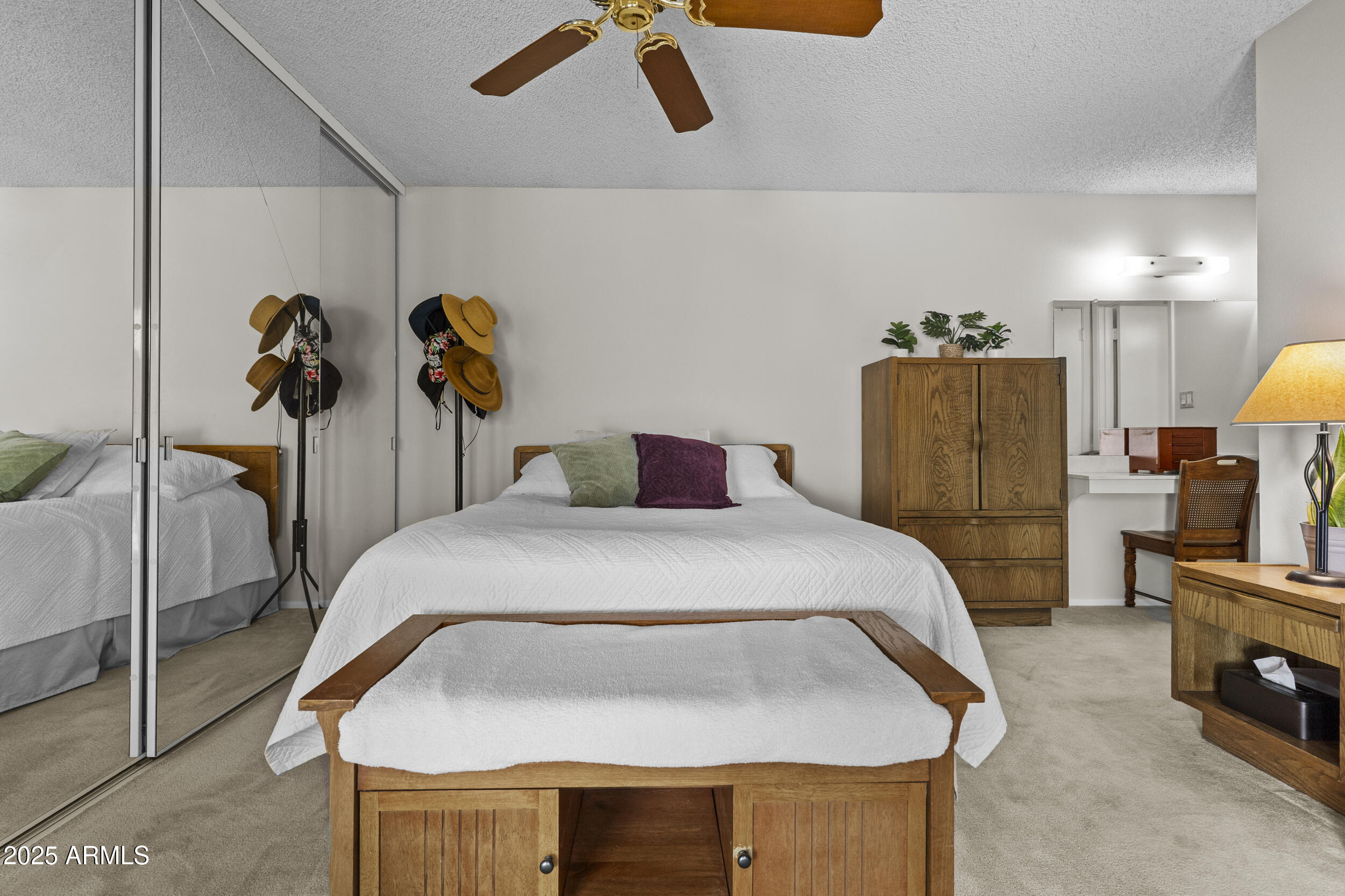 1019 East Watson Drive Tempe, AZ 85283 - Photo 17 of 46 a bedroom with a bed and a chandelier