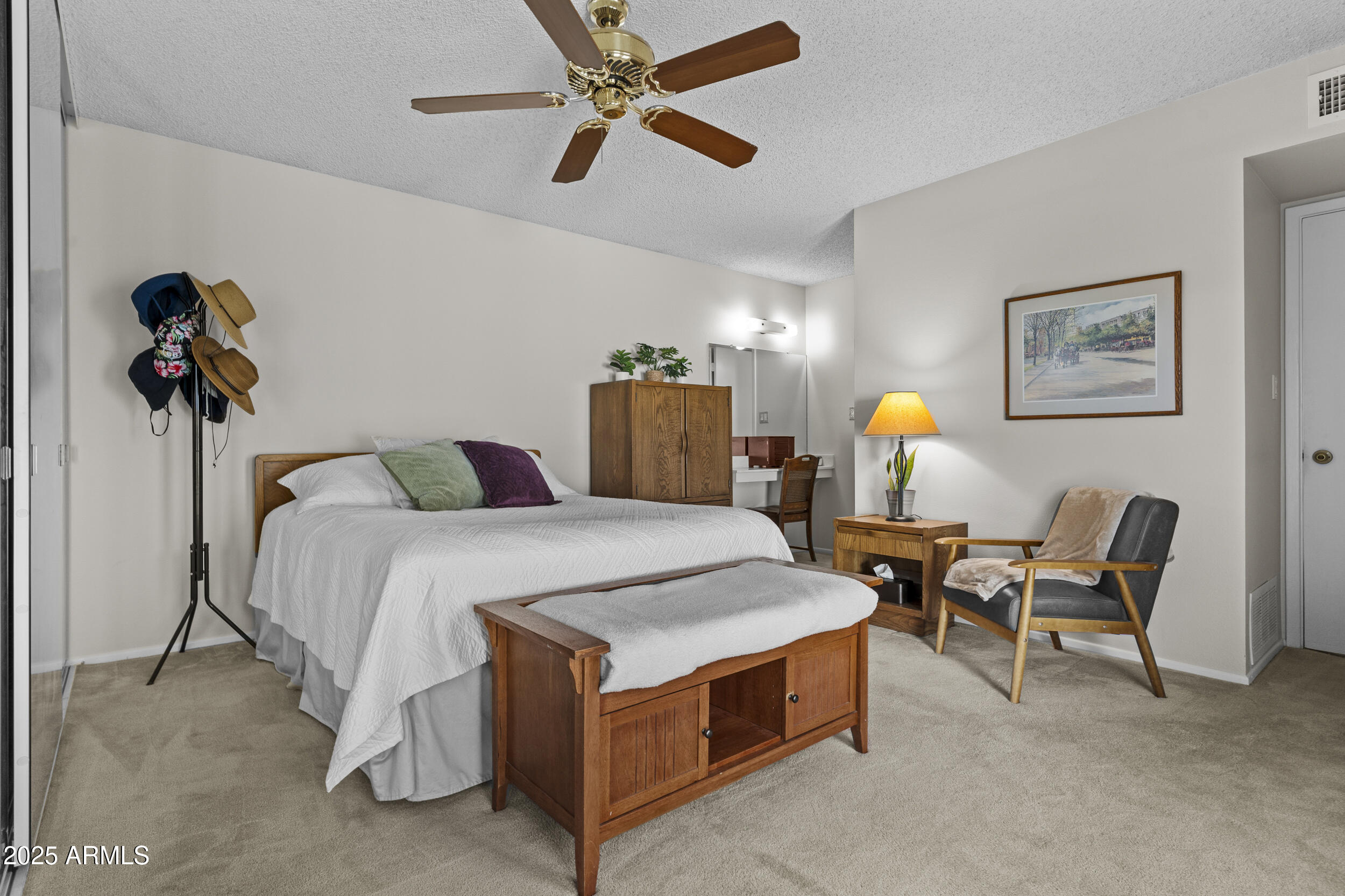 1019 East Watson Drive Tempe, AZ 85283 - Photo 18 of 46 a spacious bedroom with a bed and a chandelier