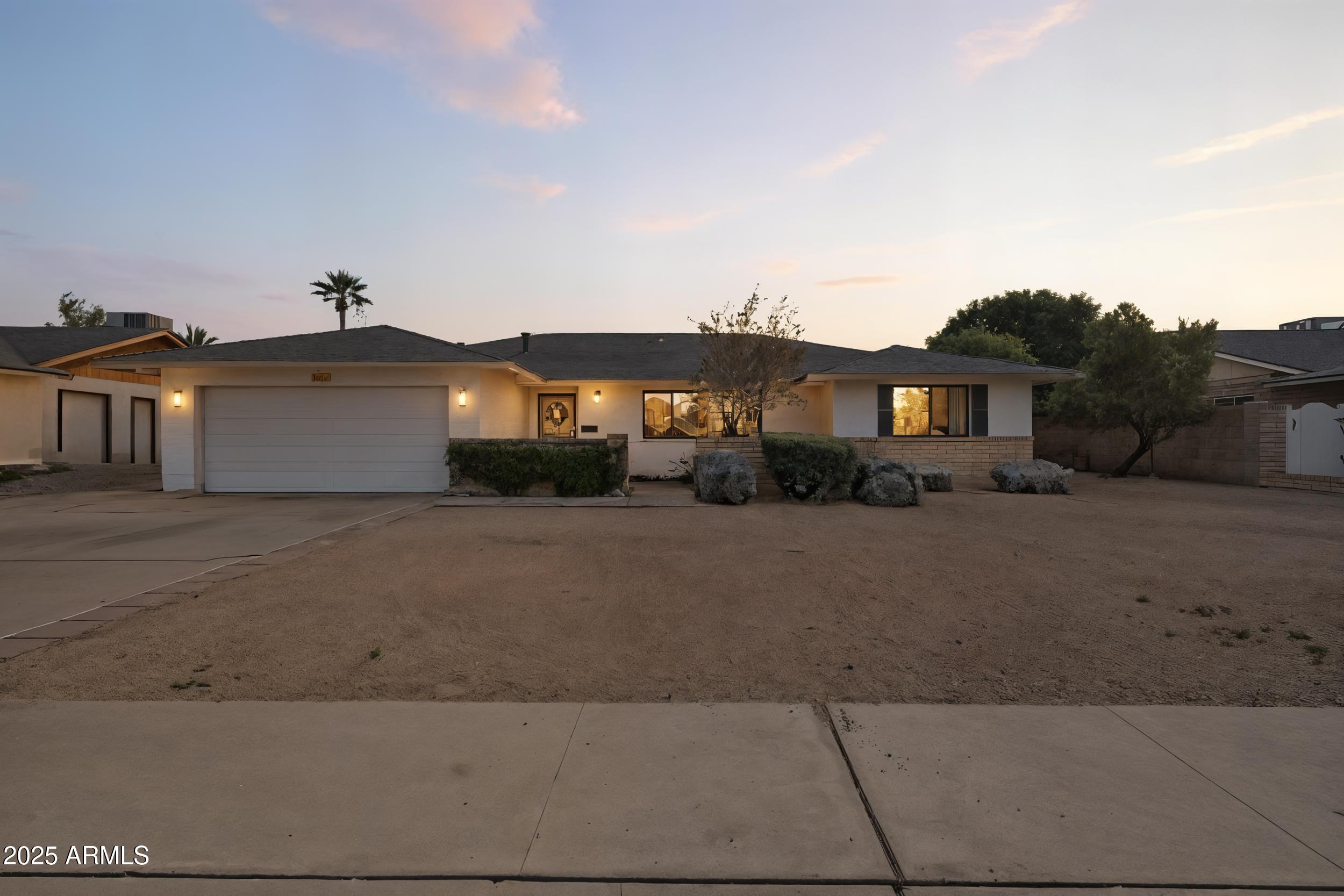 1019 East Watson Drive Tempe, AZ 85283 - Photo 4 of 46 a front view of a house with a yard and garage