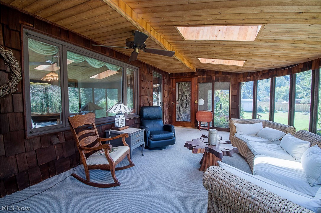 2128 Pressler Road Akron, OH 44312 - Photo 22 of 35 The gorgeous and spacious 3-seasons room offers a fantastic view of the backyard with an abundance of natural light, three skylights, and access to the stone patio.