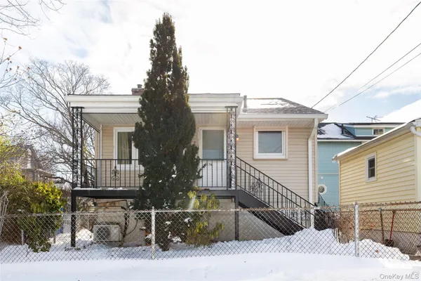 a view of a house with a wooden deck