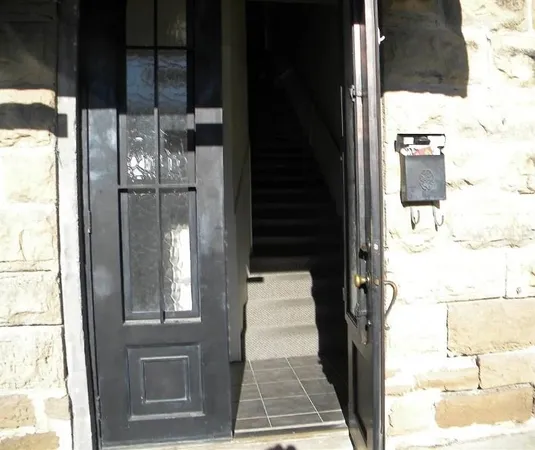 a kitchen with granite countertop a stove a sink and a refrigerator