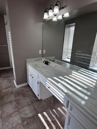 a view of a hallway with a livingroom and fireplace