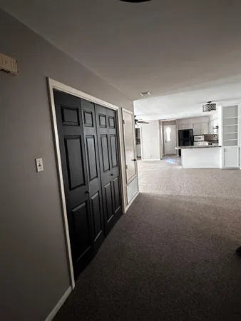 a kitchen with granite countertop a sink cabinets and stainless steel appliances