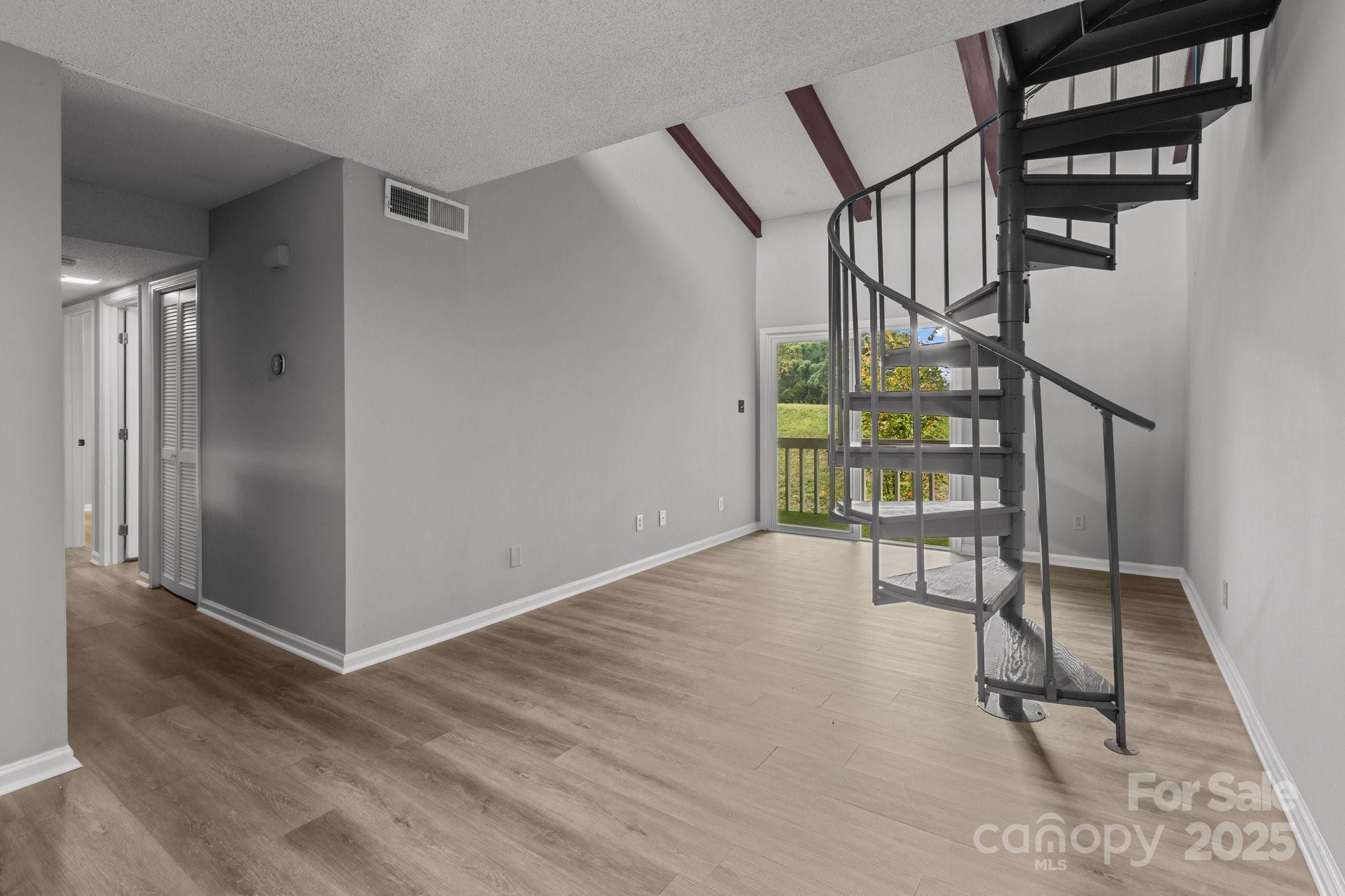 a view of an entryway with wooden floor