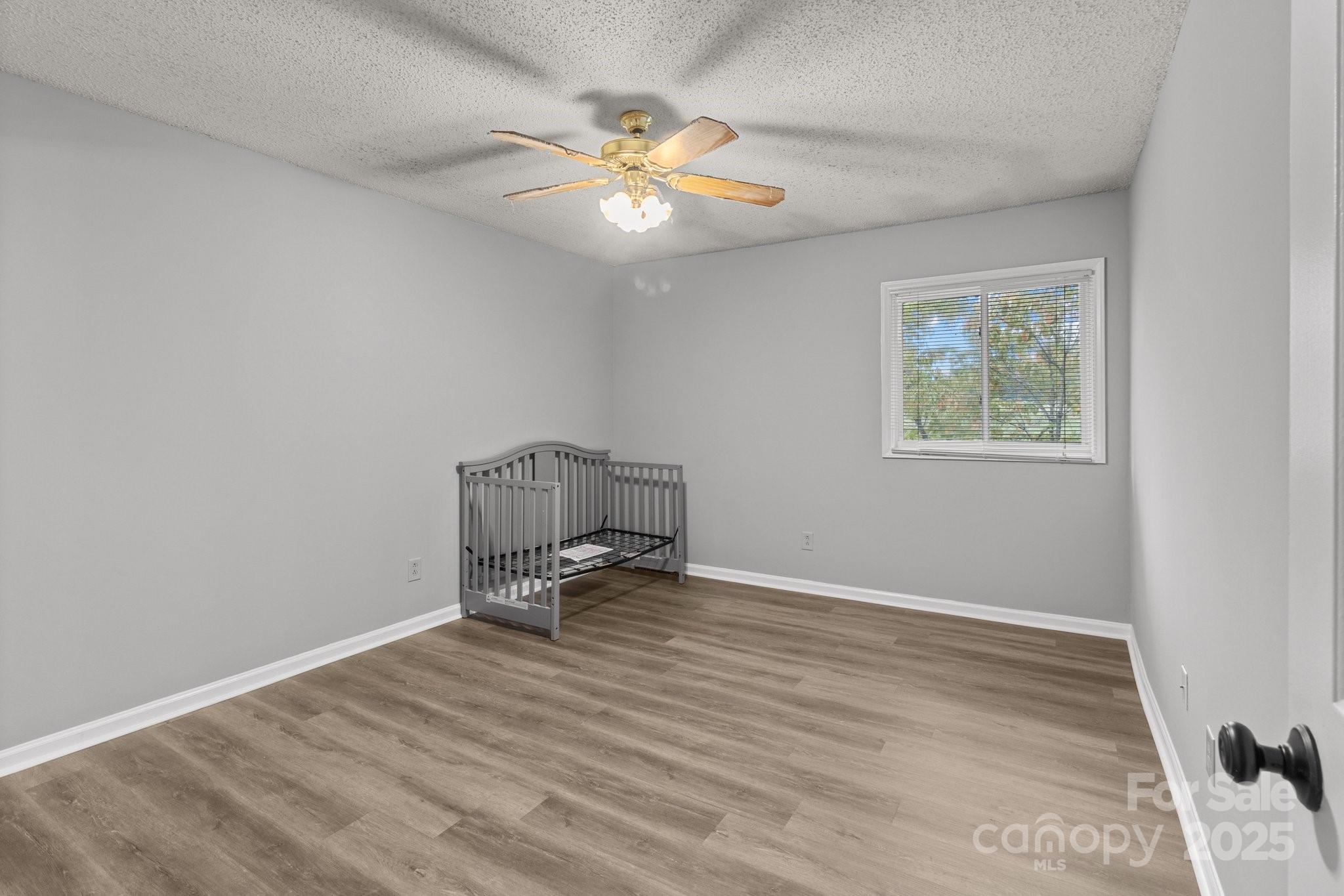 140 Lake Concord Road Northeast, Unit D9 Concord, NC 28025 - Photo 11 of 28 a view of room with wooden floor and ceiling fan