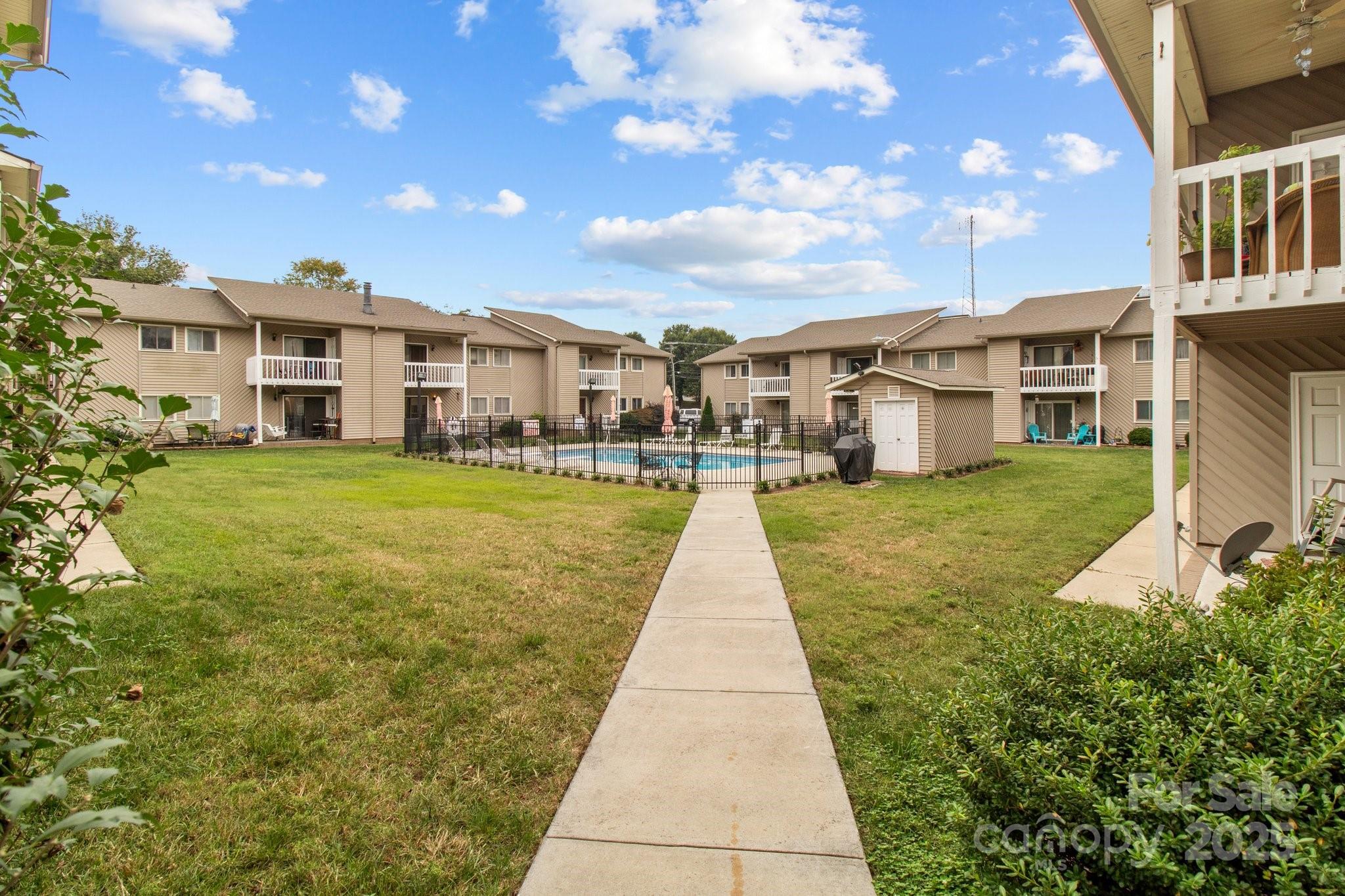 140 Lake Concord Road Northeast, Unit D9 Concord, NC 28025 - Photo 24 of 28 a view of a big yard next to a building