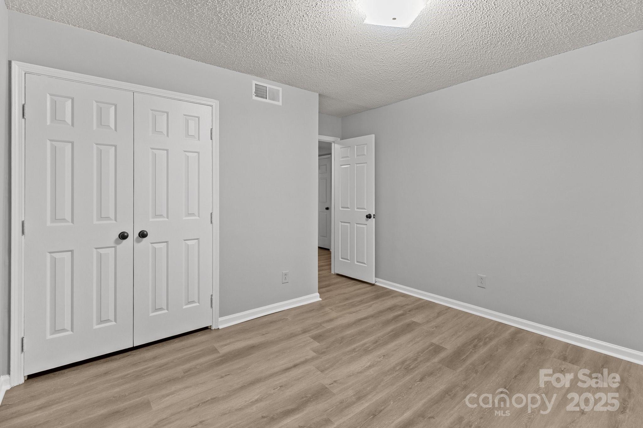 140 Lake Concord Road Northeast, Unit D9 Concord, NC 28025 - Photo 10 of 28 a view of an empty room with wooden floor