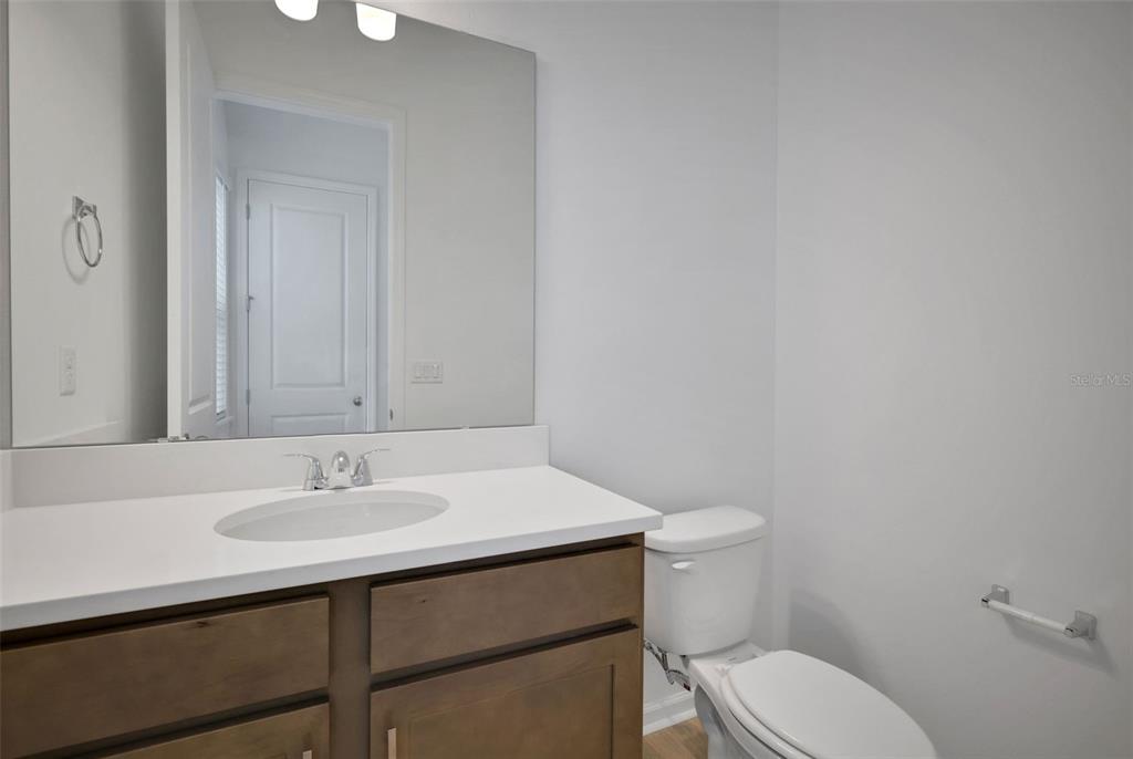 13013 Serene Glade Road Winter Garden, FL 34787 - Photo 16 of 57 a bathroom with a sink a toilet and mirror