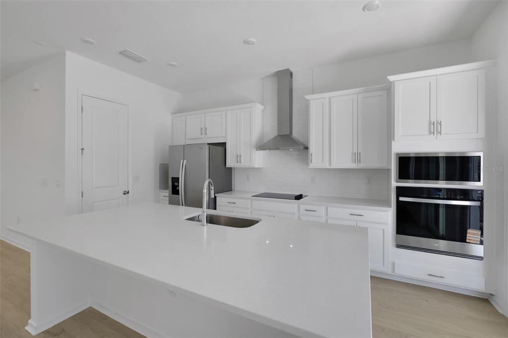 13013 Serene Glade Road Winter Garden, FL 34787 - Photo 21 of 57 a kitchen with stainless steel appliances a stove a sink and a refrigerator