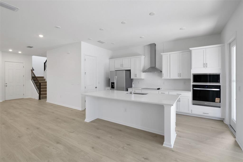 13013 Serene Glade Road Winter Garden, FL 34787 - Photo 22 of 57 a kitchen with stainless steel appliances a sink stove and cabinets