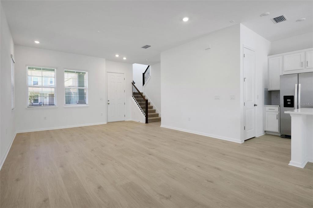 13013 Serene Glade Road Winter Garden, FL 34787 - Photo 25 of 57 a view of empty room with a kitchen and refrigerator