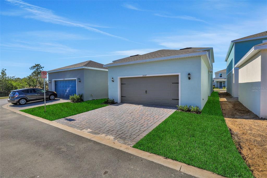 13013 Serene Glade Road Winter Garden, FL 34787 - Photo 28 of 57 a front view of a house with a yard and garage