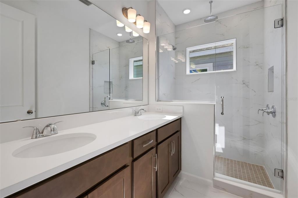 13013 Serene Glade Road Winter Garden, FL 34787 - Photo 10 of 57 a bathroom with a sink double vanity and shower