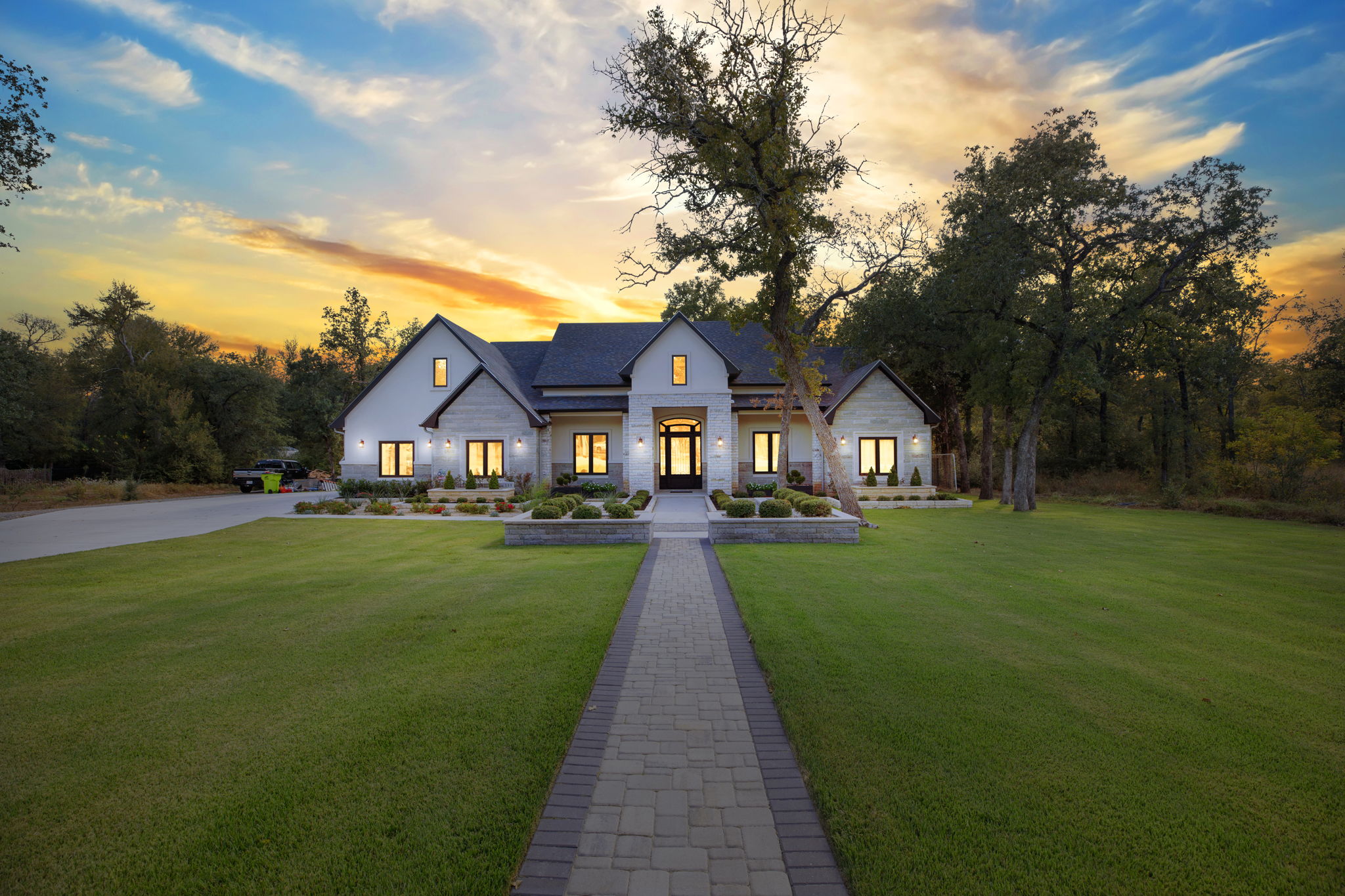 a front view of a house with yard and green space
