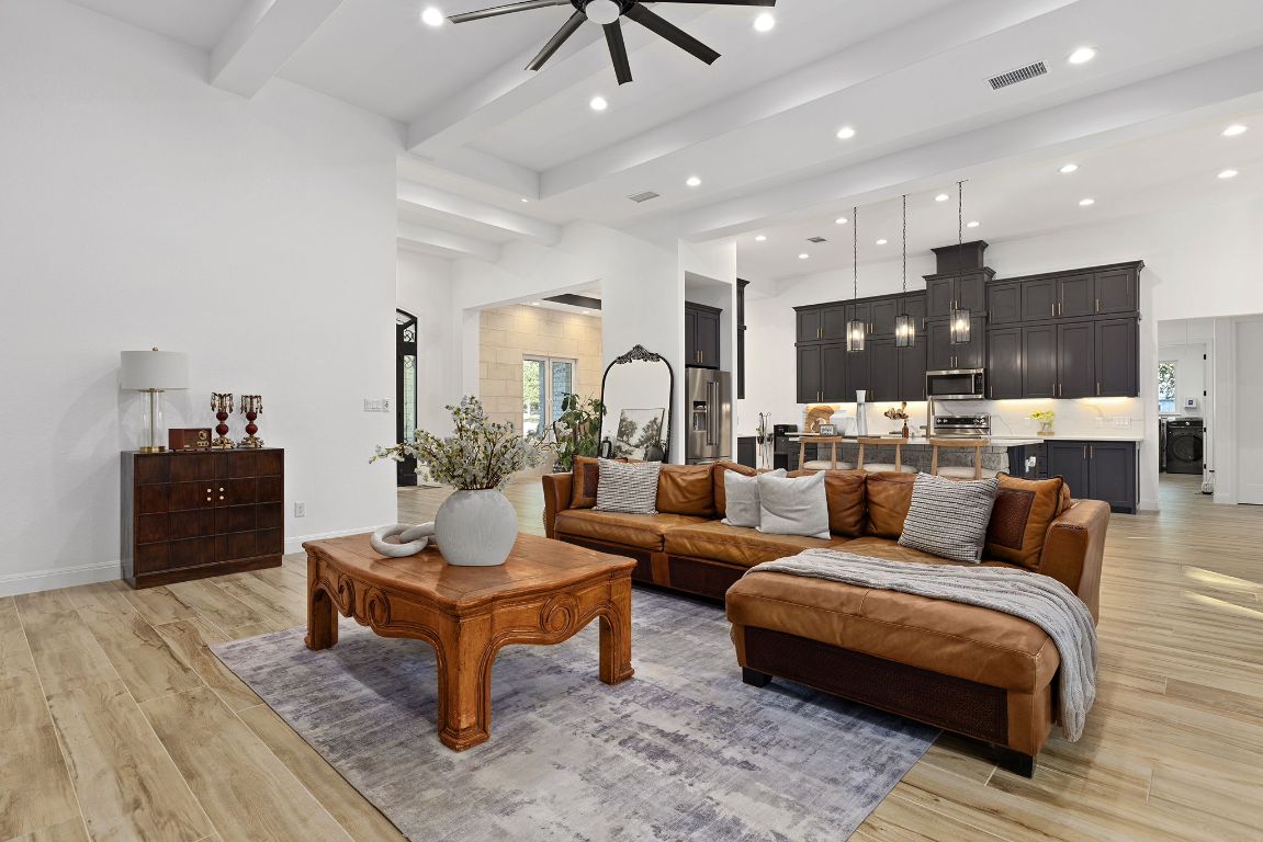 153 Fawn Hollow Elgin, TX 78621 - Photo 19 of 40 Living area featuring beam ceiling, light wood finished floors, ceiling fan, and recessed lighting