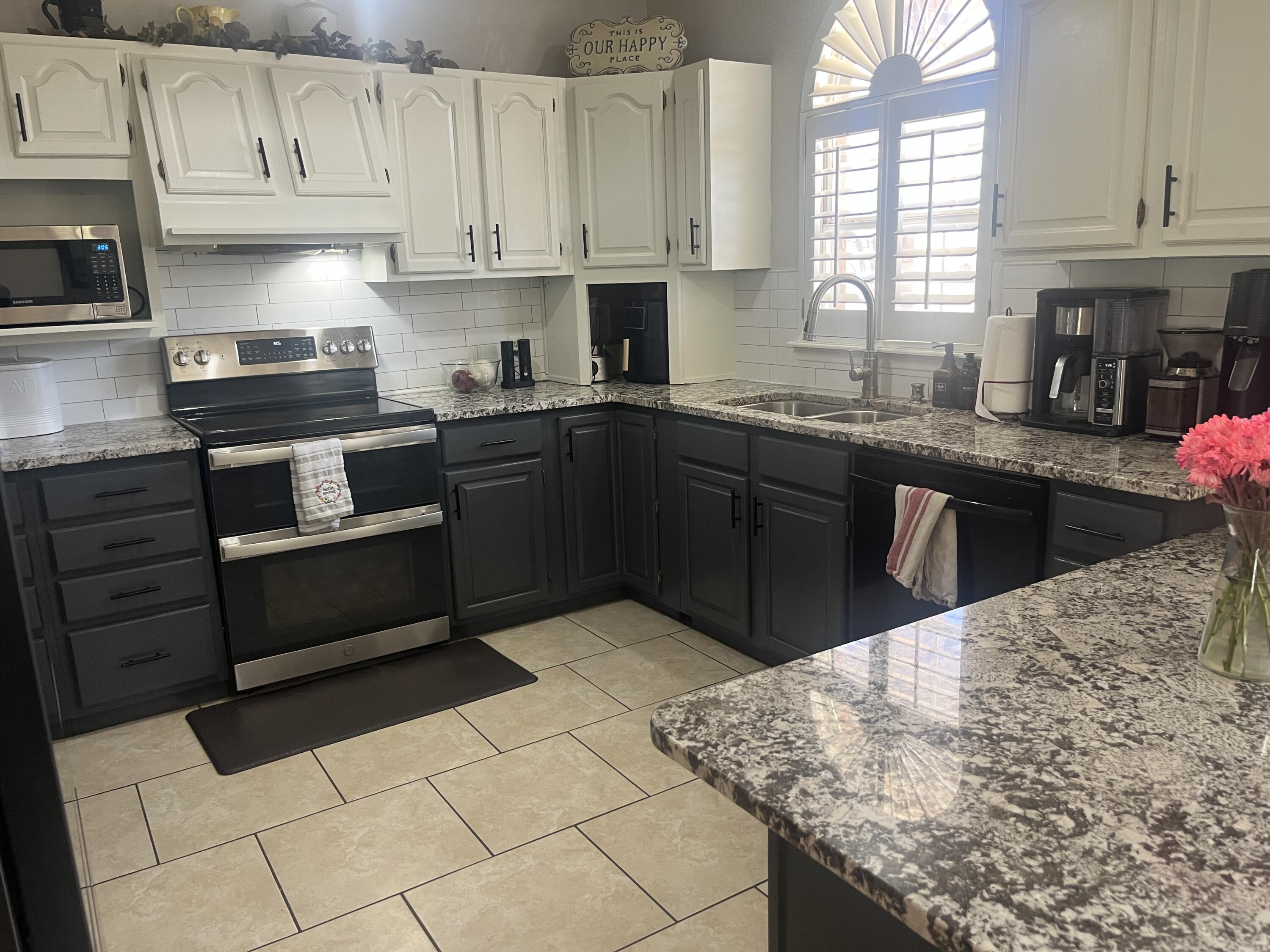 2222 South 2nd Place Lamesa, TX 79331 - Photo 11 of 44 a kitchen with granite countertop a stove sink and cabinets