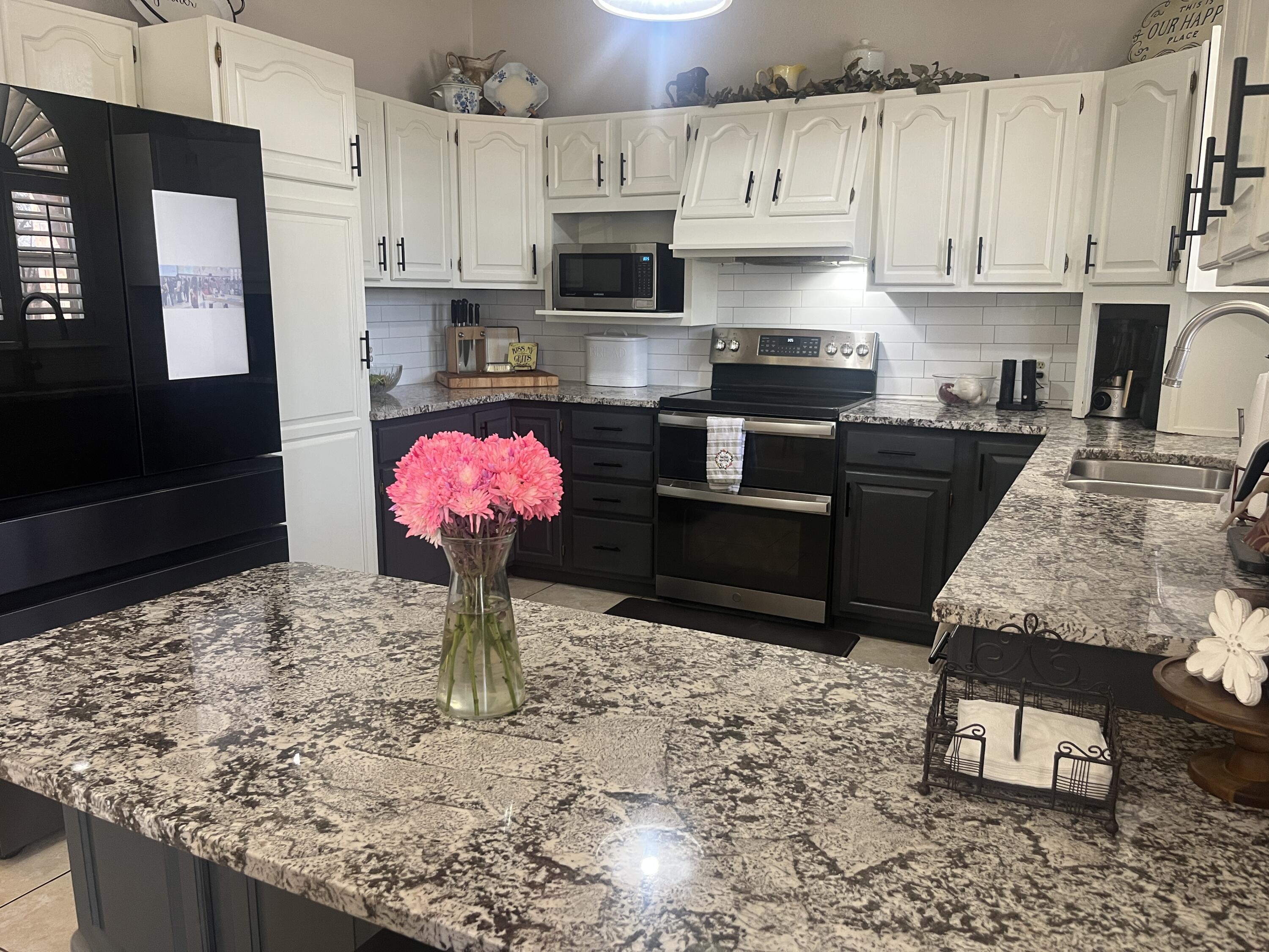 2222 South 2nd Place Lamesa, TX 79331 - Photo 12 of 44 a kitchen with granite countertop a stove a sink and a refrigerator