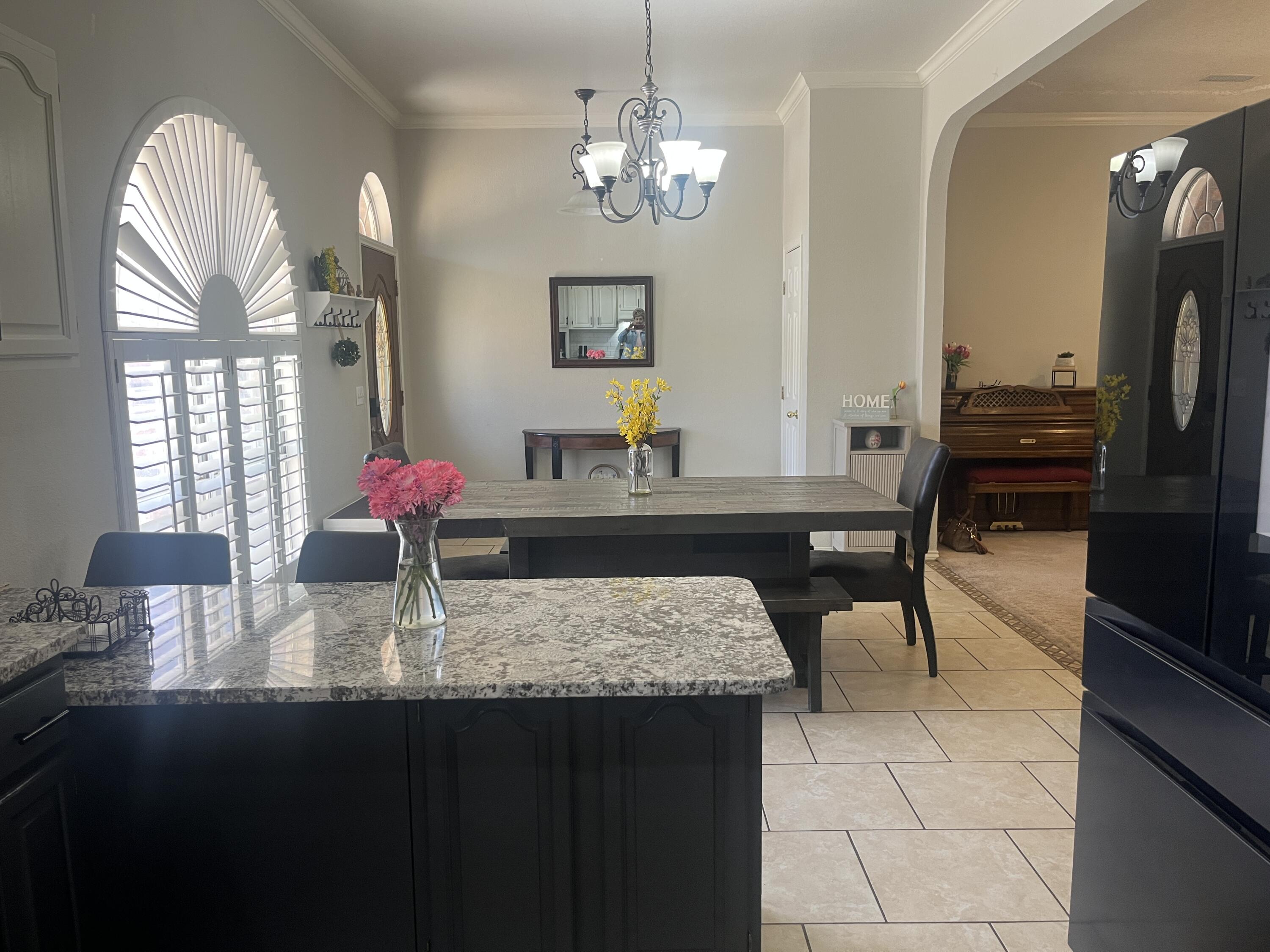 2222 South 2nd Place Lamesa, TX 79331 - Photo 15 of 44 a view of a dining room with furniture and chandelier
