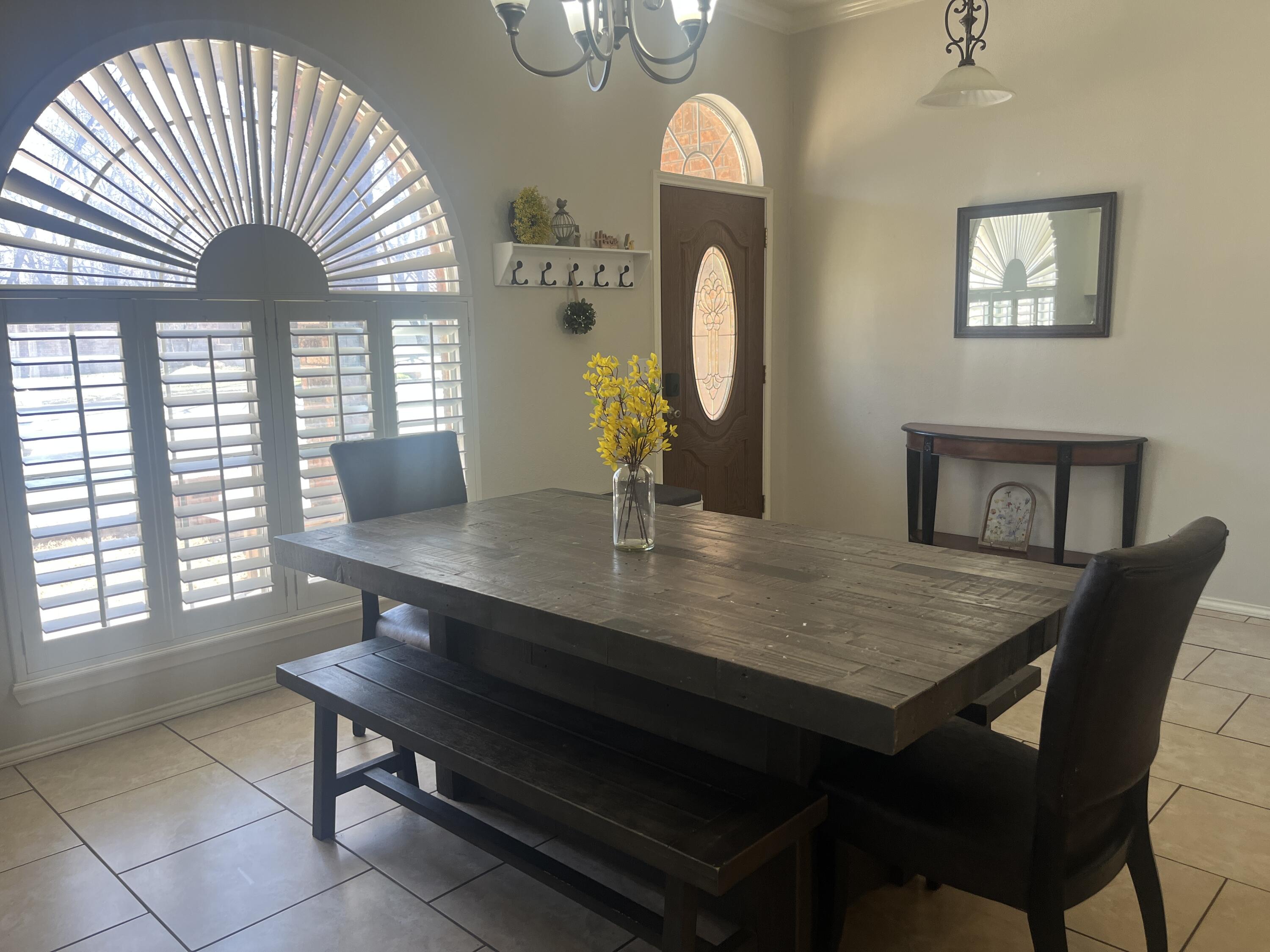 2222 South 2nd Place Lamesa, TX 79331 - Photo 16 of 44 a view of a dining room with furniture wooden floor and chandelier