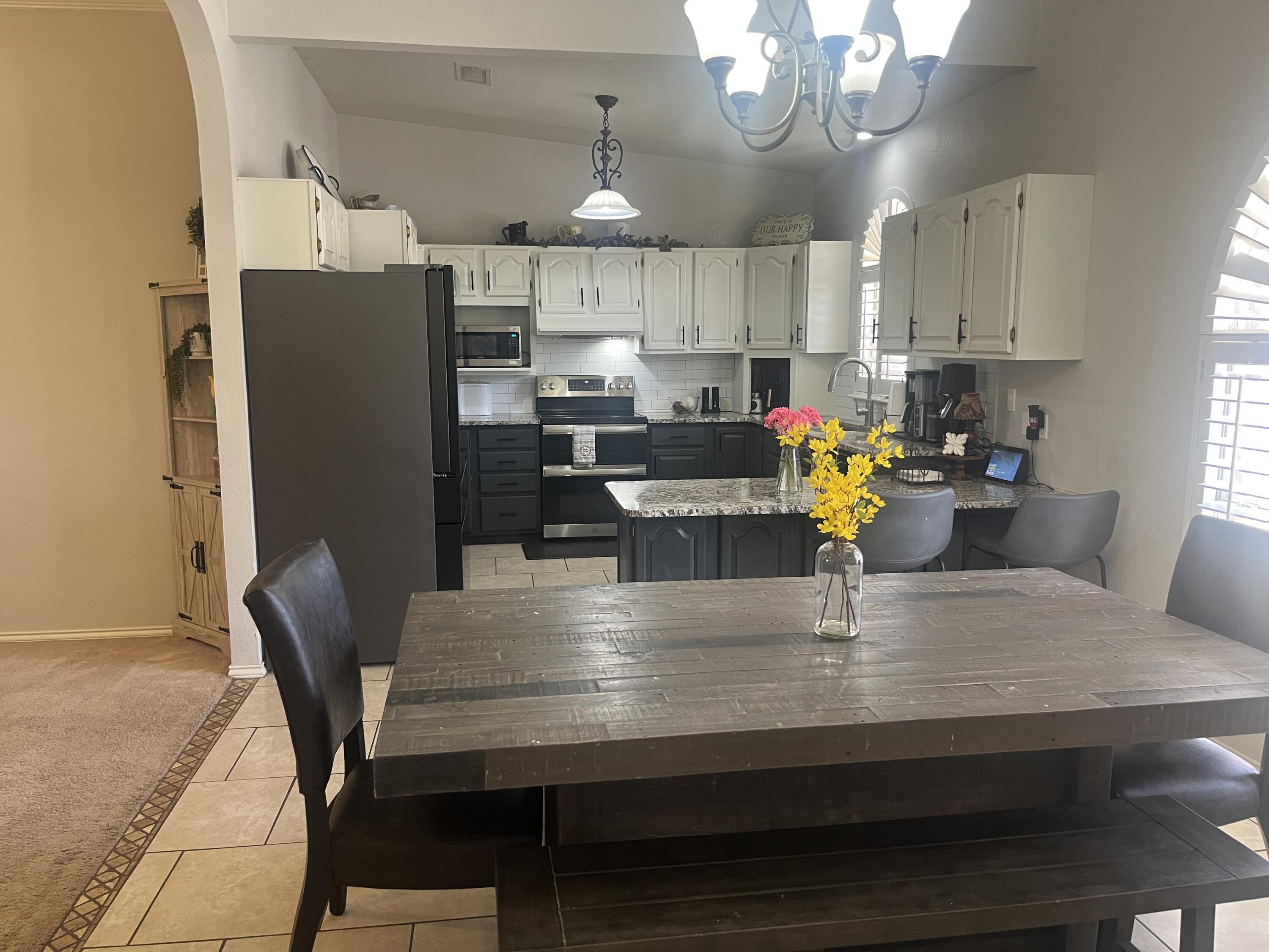 2222 South 2nd Place Lamesa, TX 79331 - Photo 18 of 44 a kitchen with stainless steel appliances granite countertop a kitchen island a stove a table and chairs
