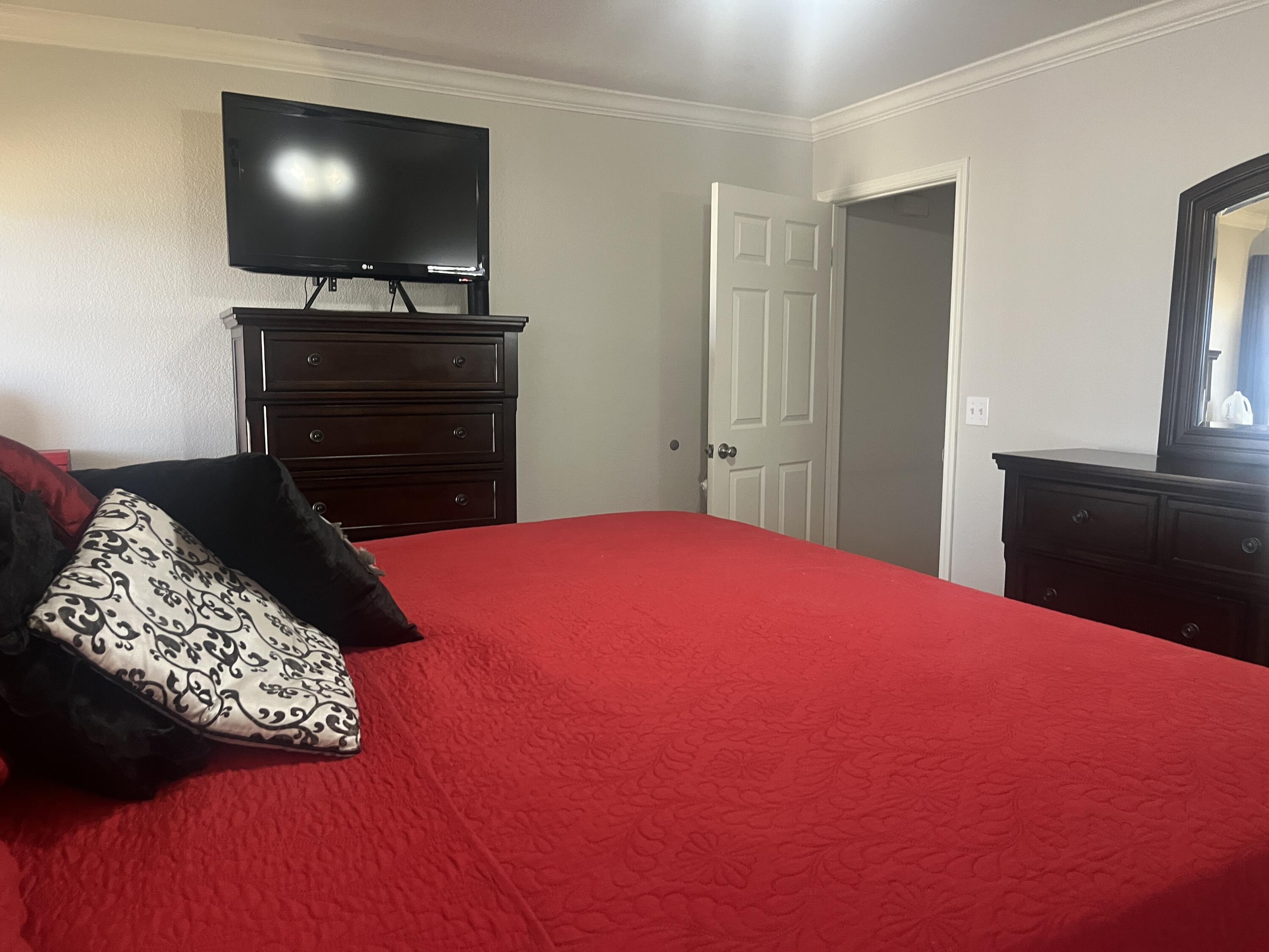 2222 South 2nd Place Lamesa, TX 79331 - Photo 19 of 44 a bedroom with a bed and a flat screen tv