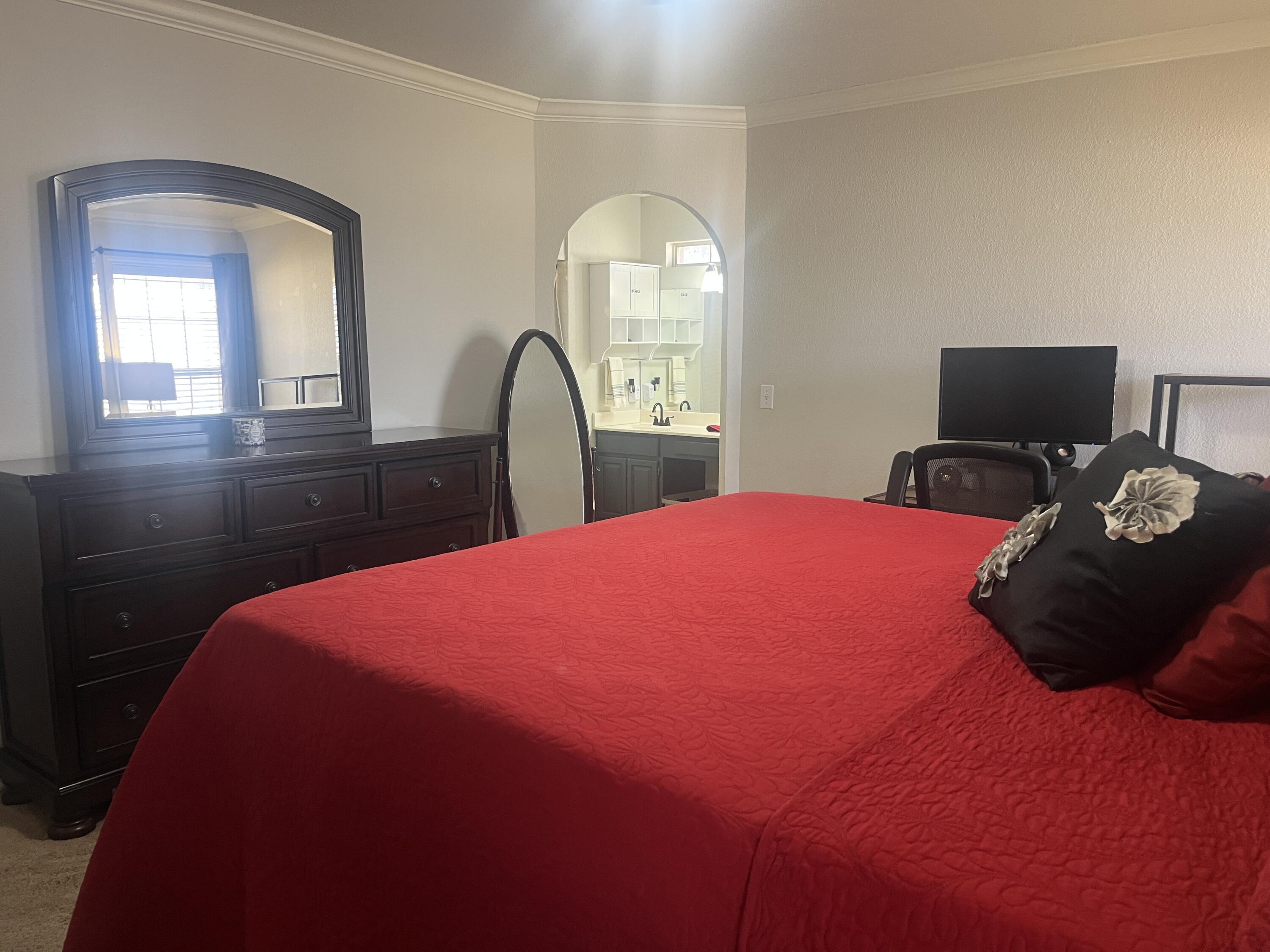 2222 South 2nd Place Lamesa, TX 79331 - Photo 20 of 44 a bedroom with a bed window and dresser