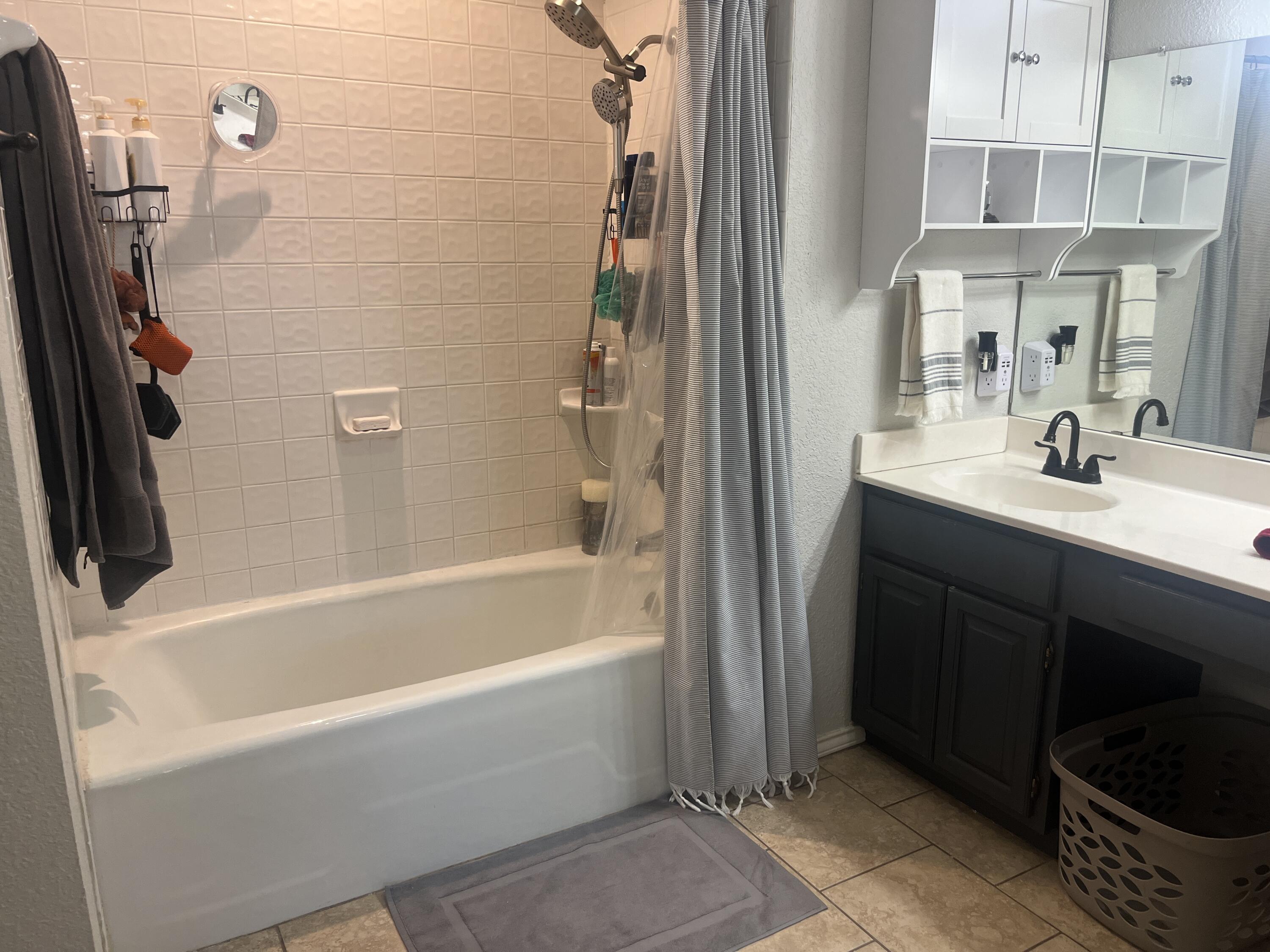 2222 South 2nd Place Lamesa, TX 79331 - Photo 24 of 44 a bathroom with a bathtub sink and mirror