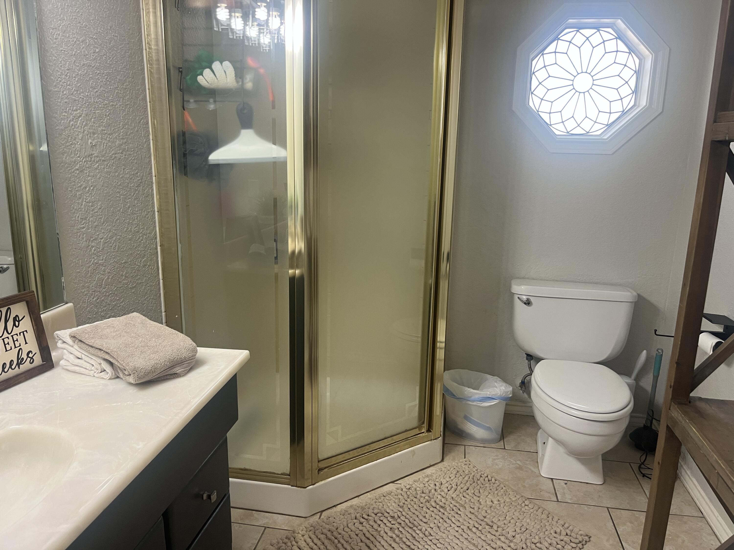 2222 South 2nd Place Lamesa, TX 79331 - Photo 31 of 44 a bathroom with a granite countertop sink toilet and shower