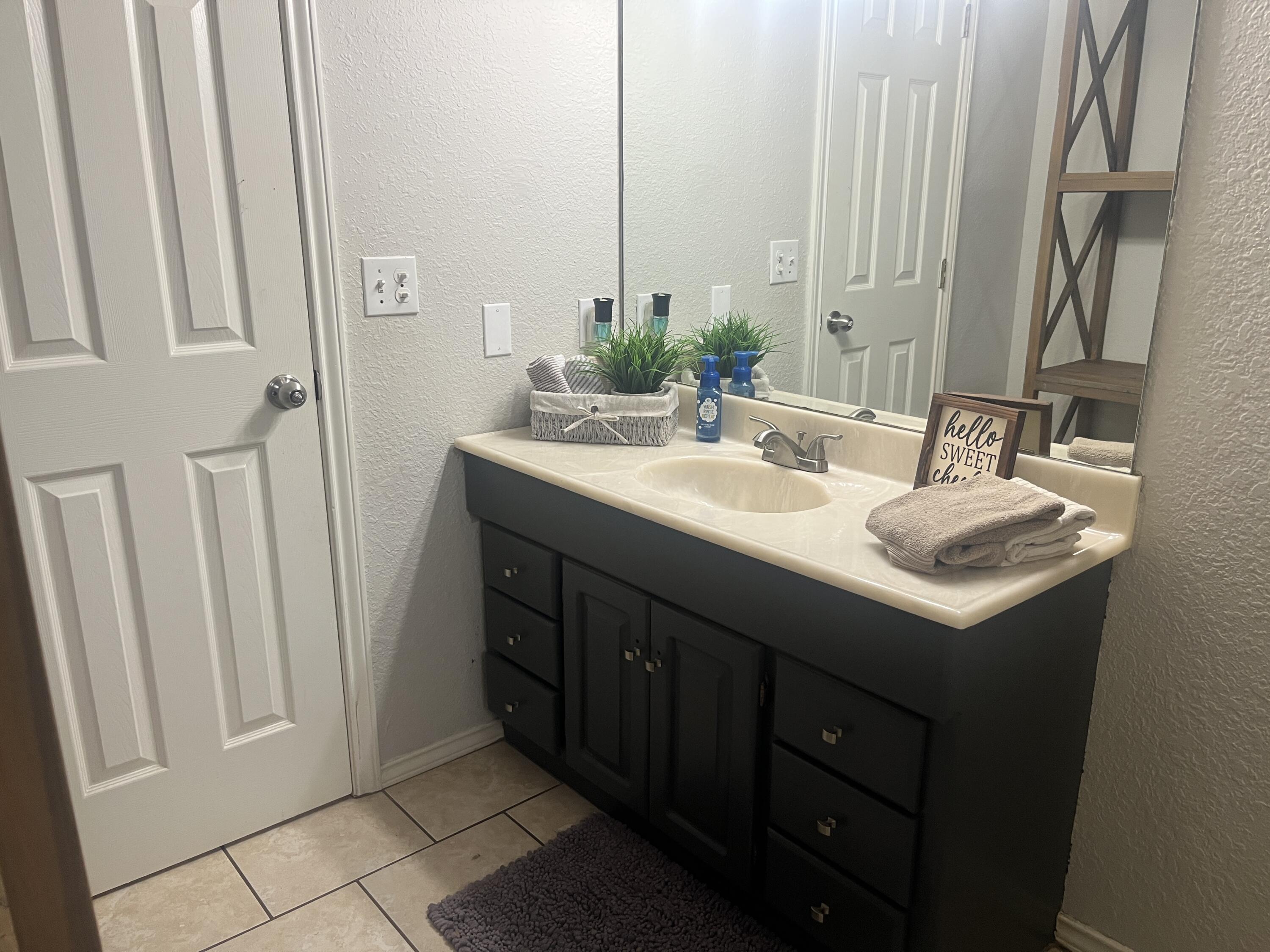 2222 South 2nd Place Lamesa, TX 79331 - Photo 33 of 44 a bathroom with a sink and a mirror